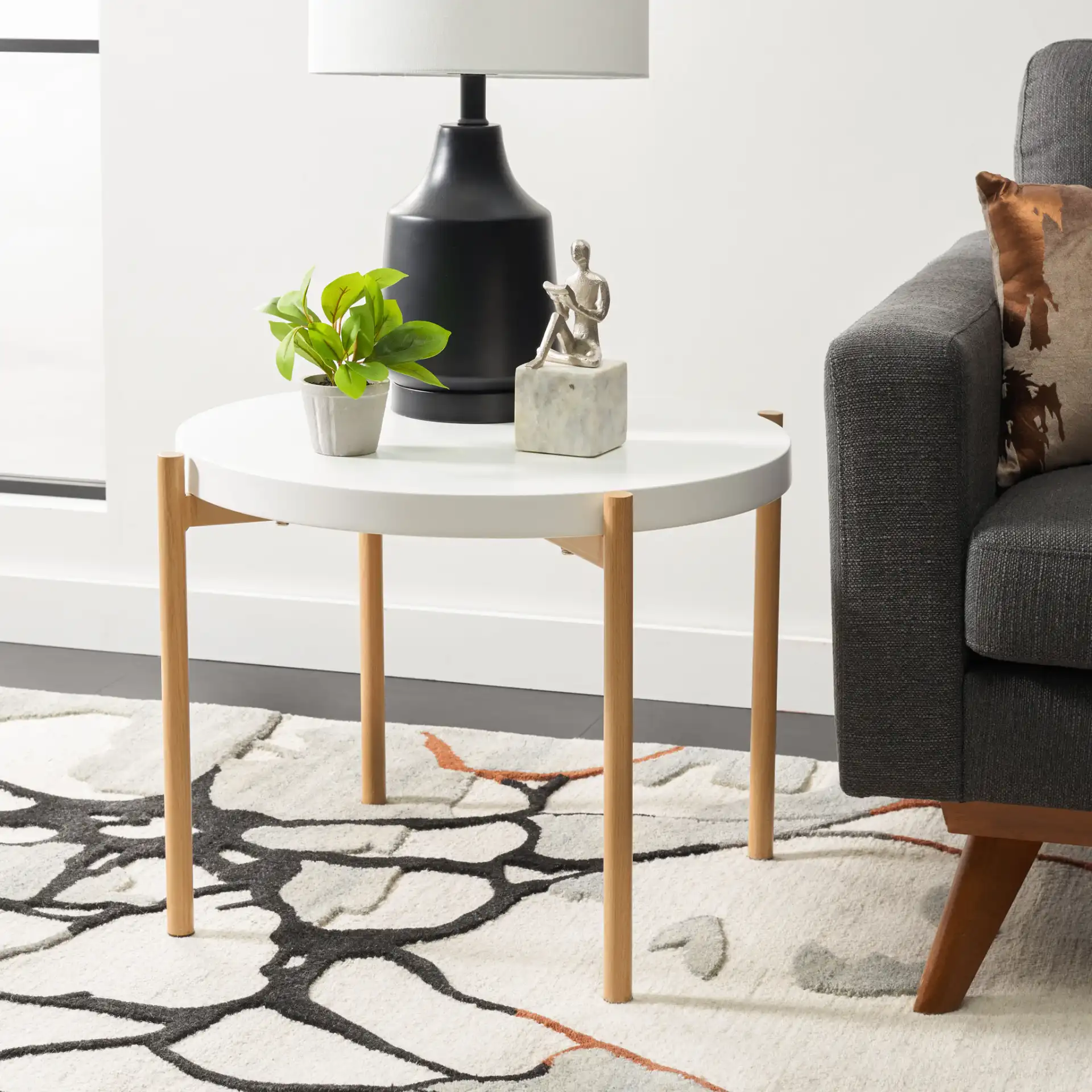 Solara Accent Table in White / Gold in a styled room