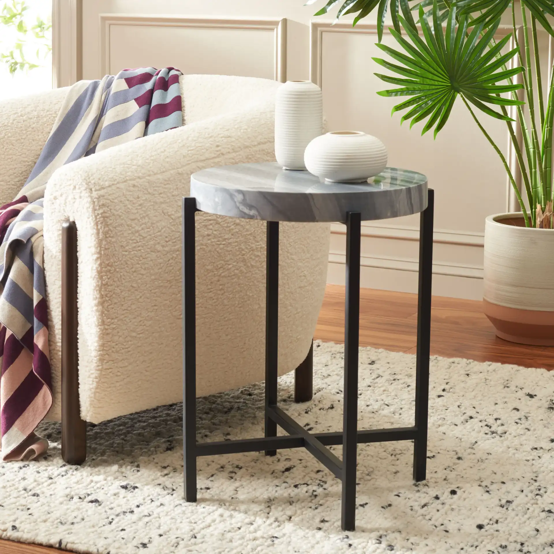 Gustavia Round Accent Table in Gray Marble / Black in a styled room