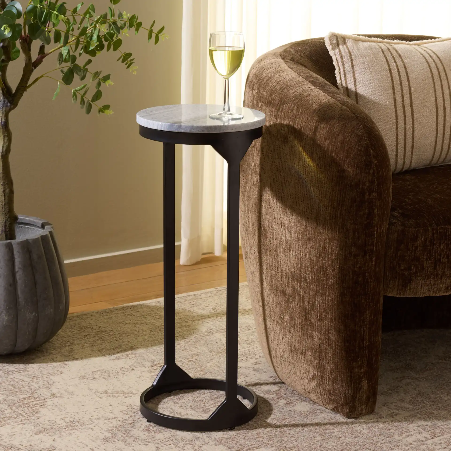 Daedalus Round Drink Accent Table in Gray Marble / Black in a styled room