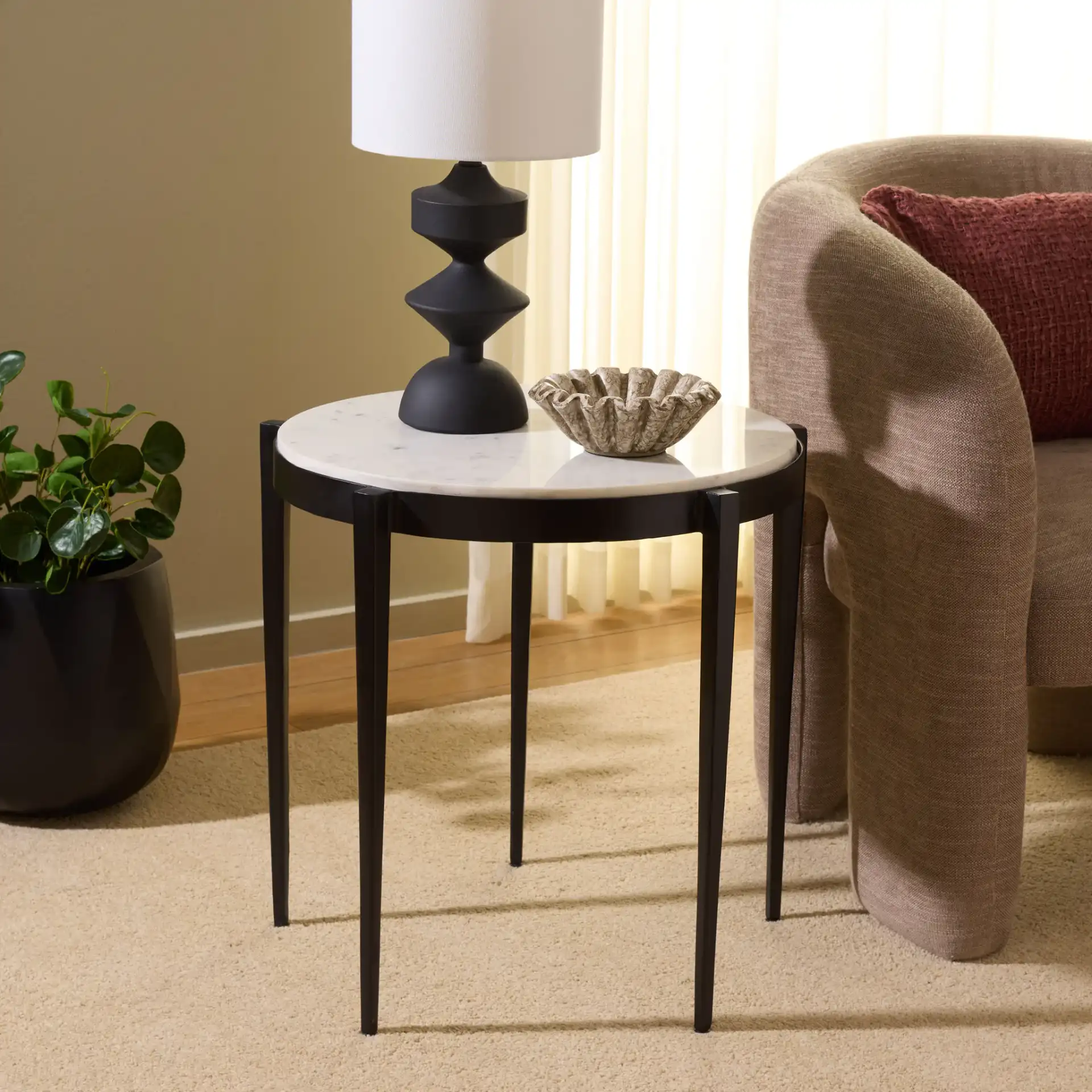 Dolores Round Accent Table in White Marble / Black in a styled room