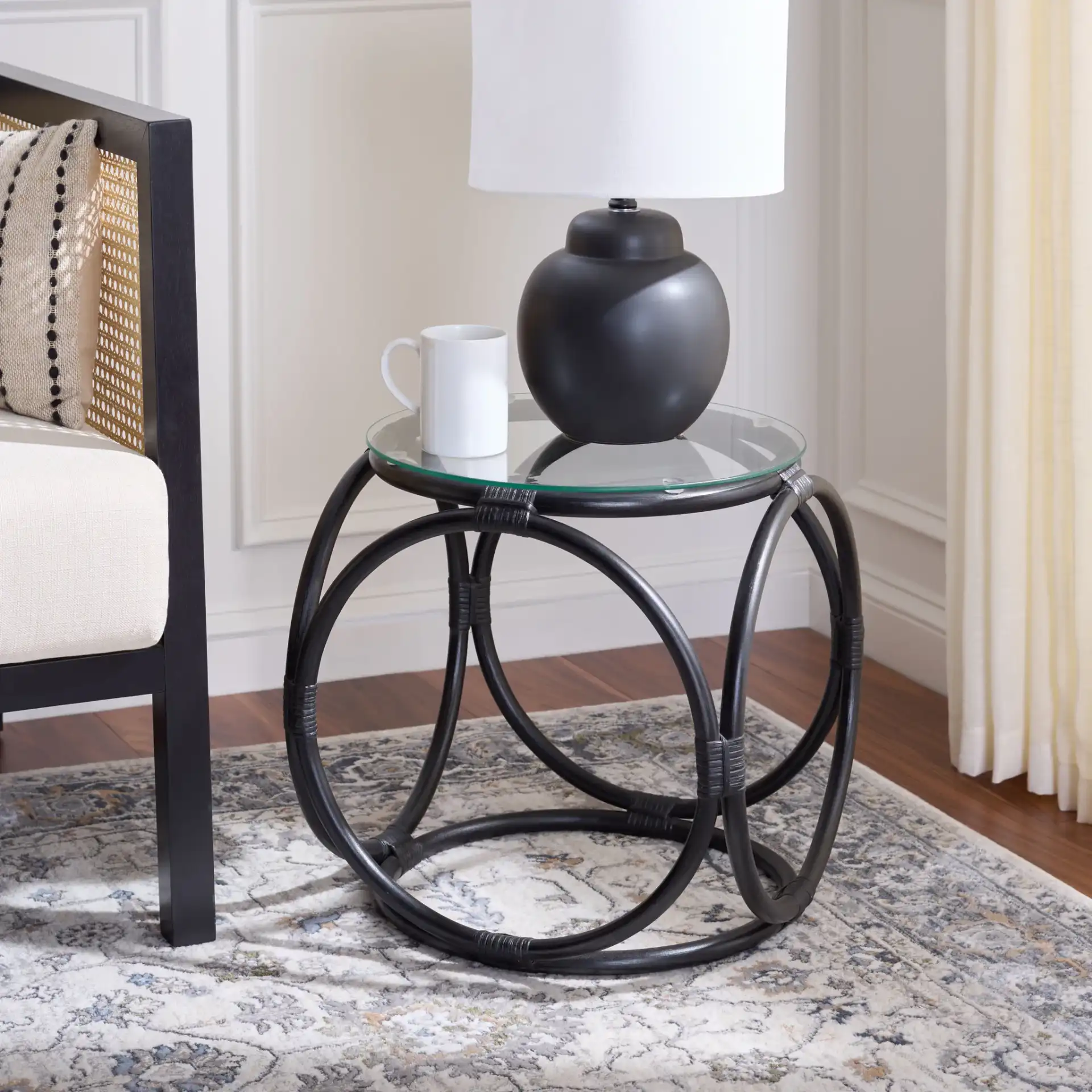 Alesha Round Accent Table in Black / Glass in a styled room