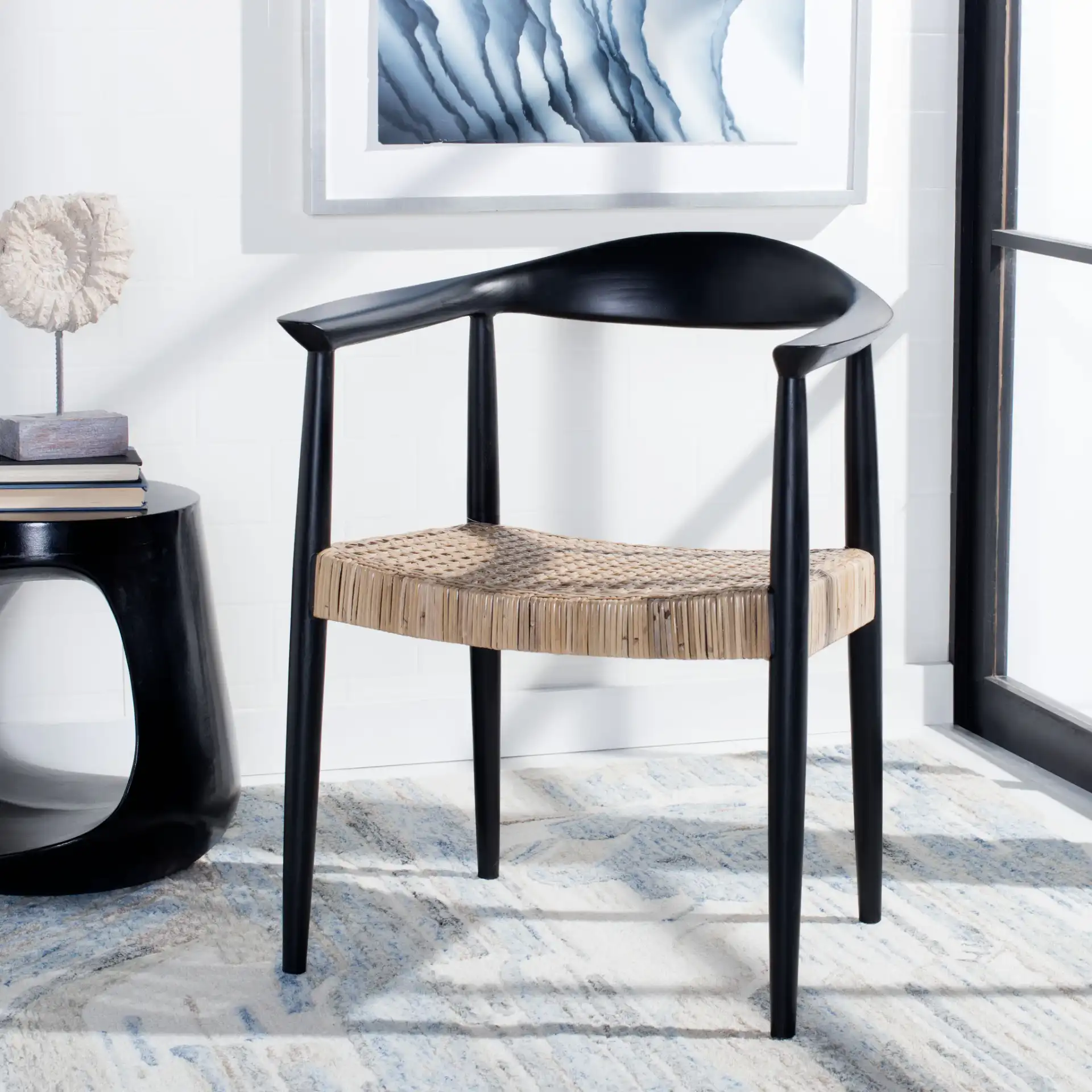 Eyre Rattan Peel Accent Chair in Black / Brown in a styled room