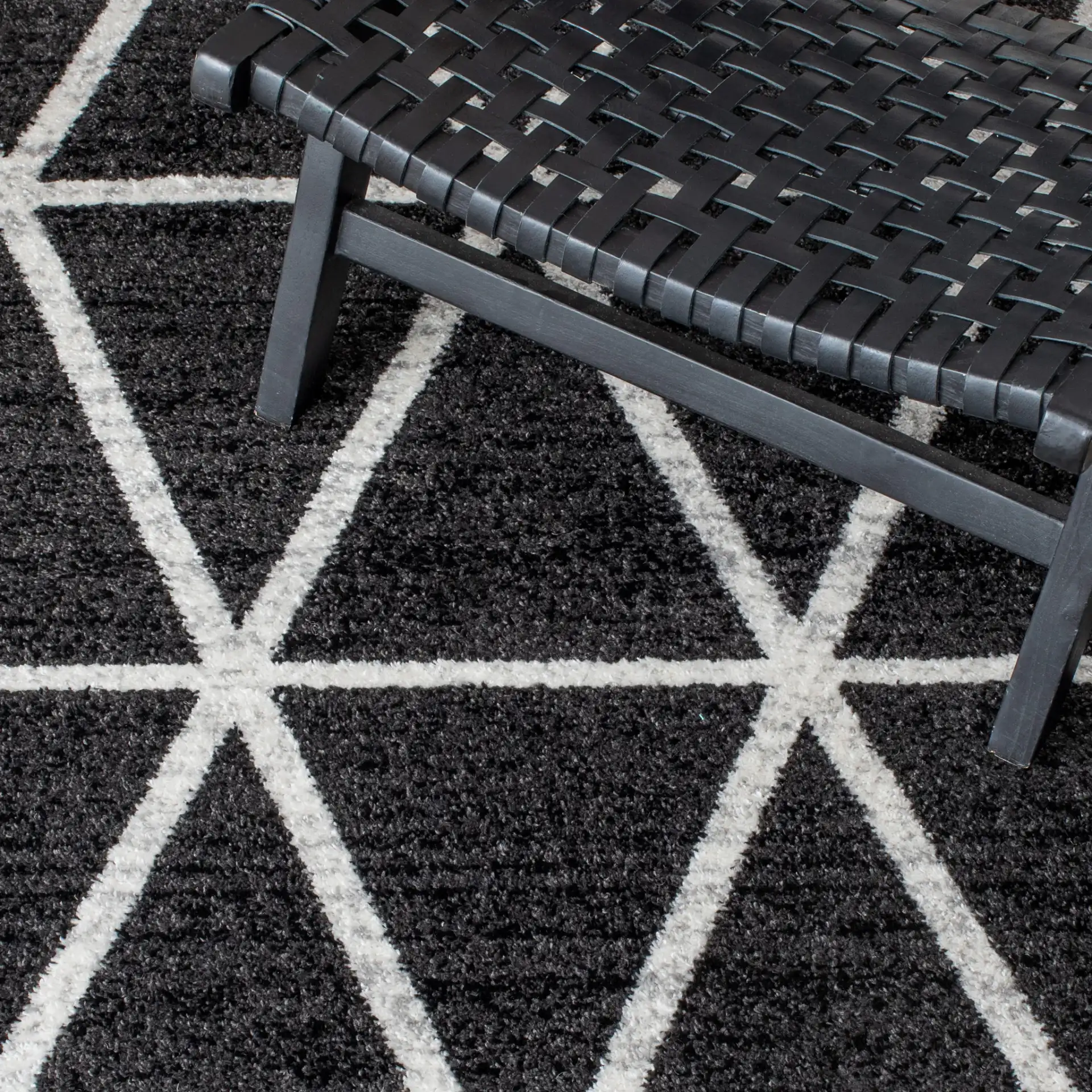 Adirondack Triangle Grid Rug in Black / Ivory in a styled room