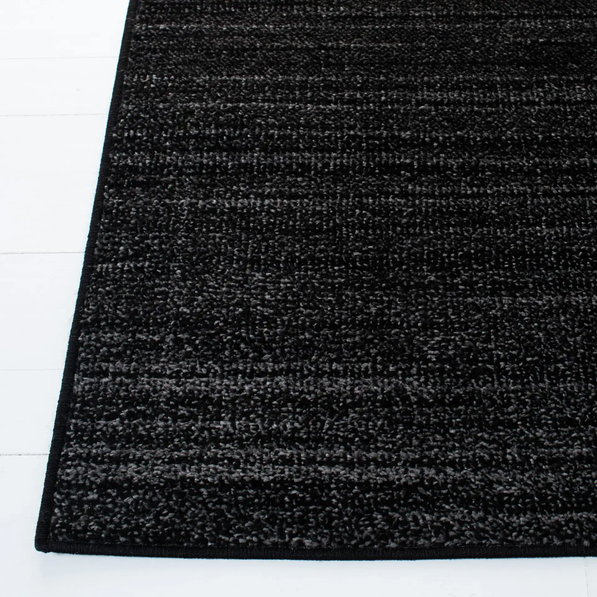 Adirondack Linear Striated Rug in Black / Ivory in a styled room