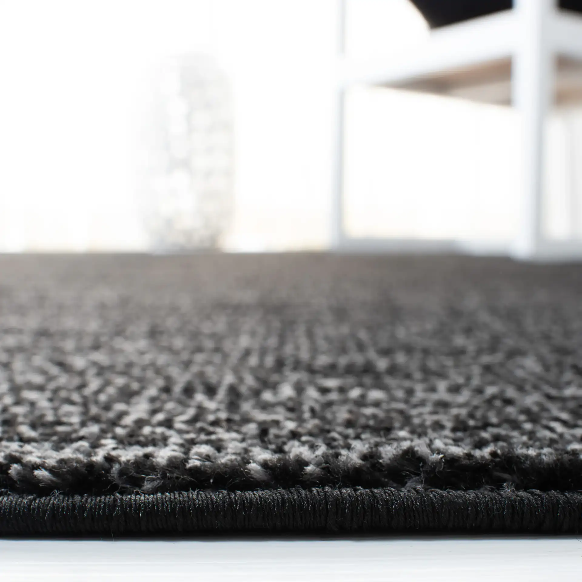Adirondack Linear Striated Rug in Black / Ivory in a styled room