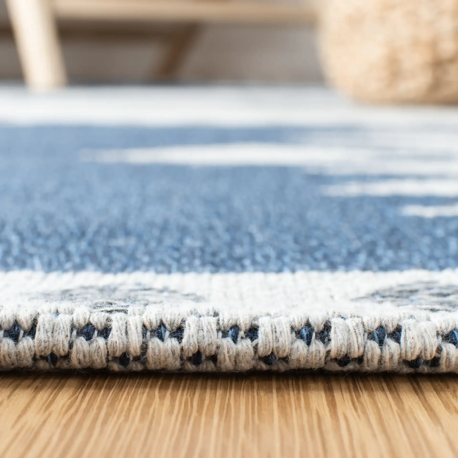 Augustine Banded Diamond Cotton Rug in Navy / Cream in a styled room