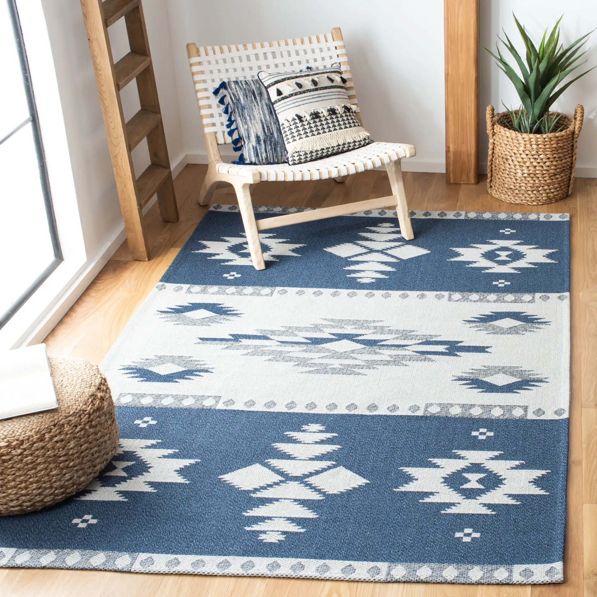 Augustine Banded Diamond Cotton Rug in Navy / Cream in a styled room