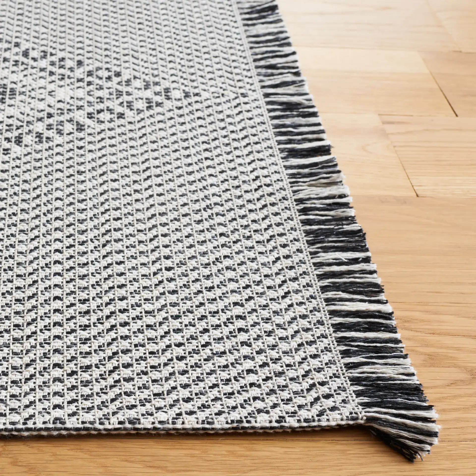 Augustine Concentric Diamond Rug in Ivory / Black in a styled room