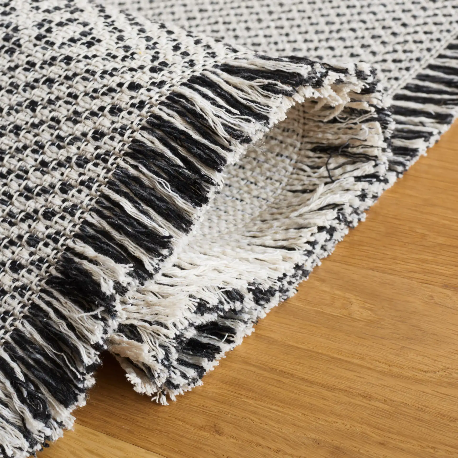 Augustine Concentric Diamond Rug in Ivory / Black in a styled room