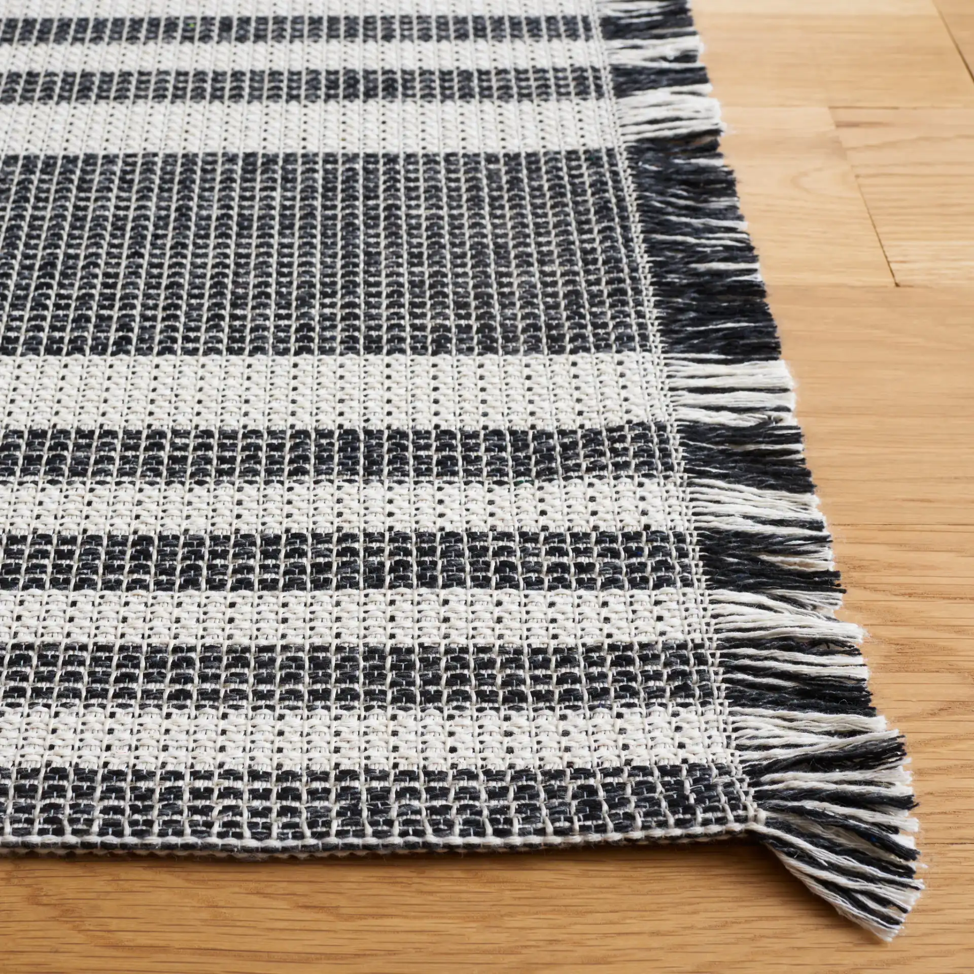 Augustine Striped Rug in Ivory / Black in a styled room