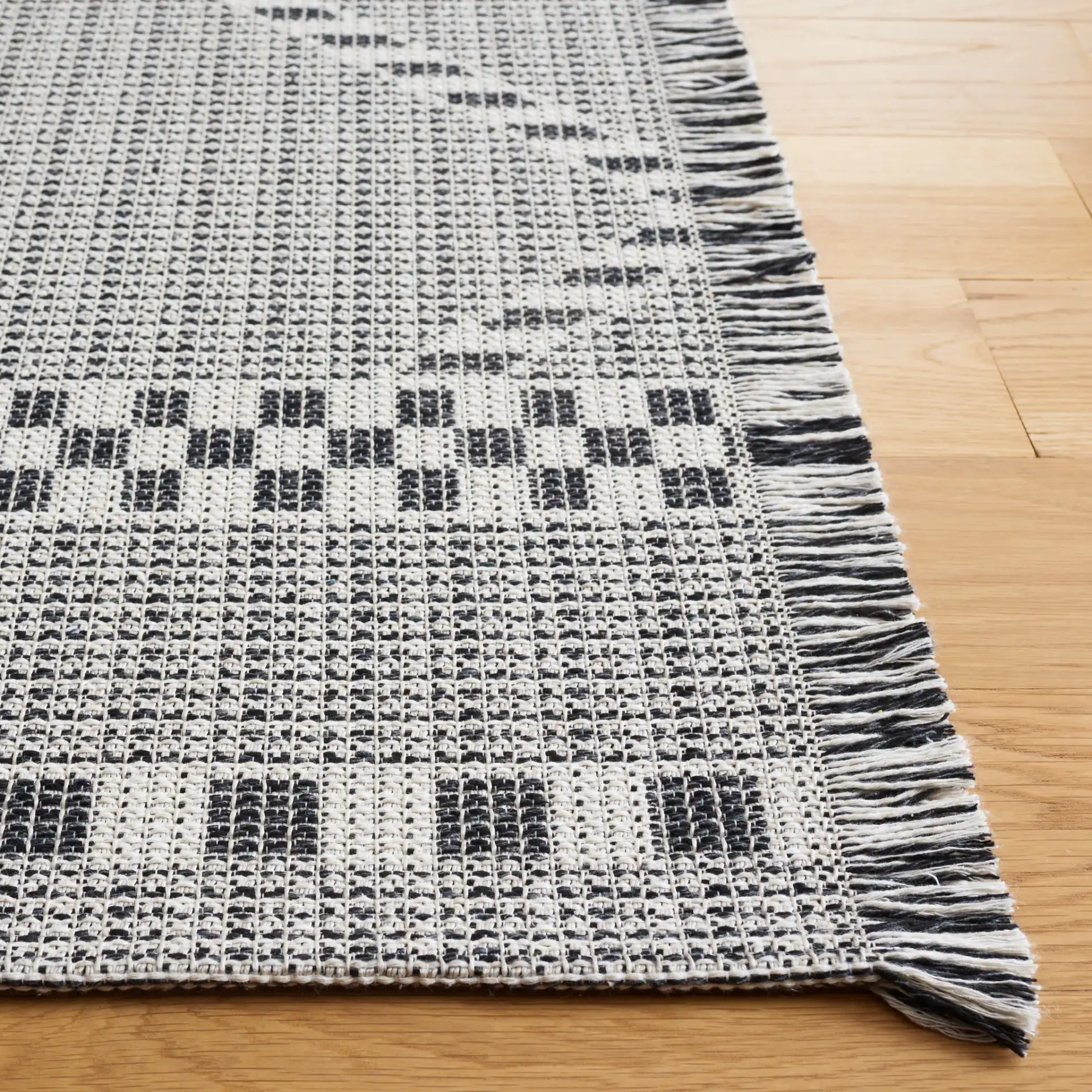 Augustine Large Scale Diamond Rug in Ivory / Black in a styled room