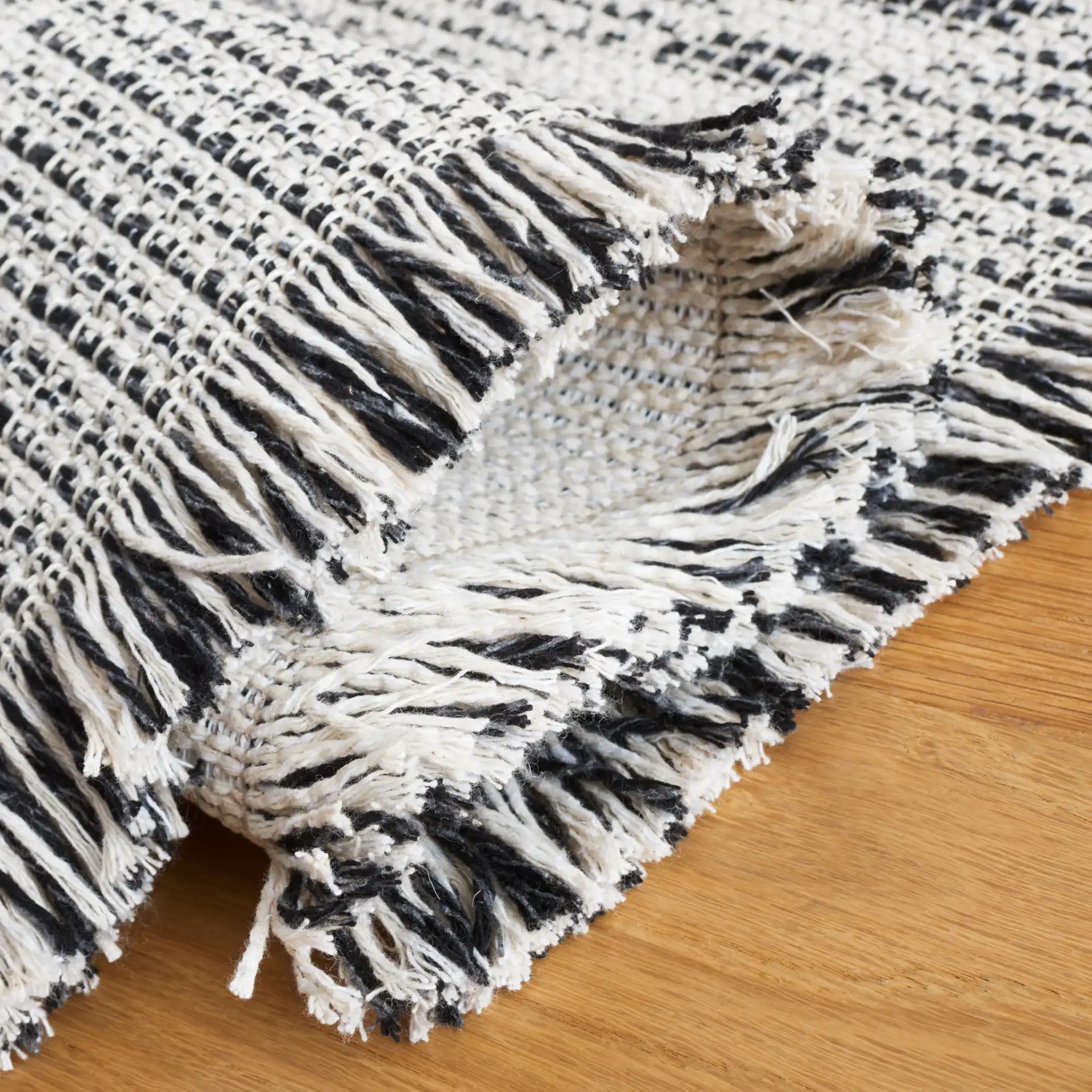 Augustine Large Scale Diamond Rug in Ivory / Black in a styled room
