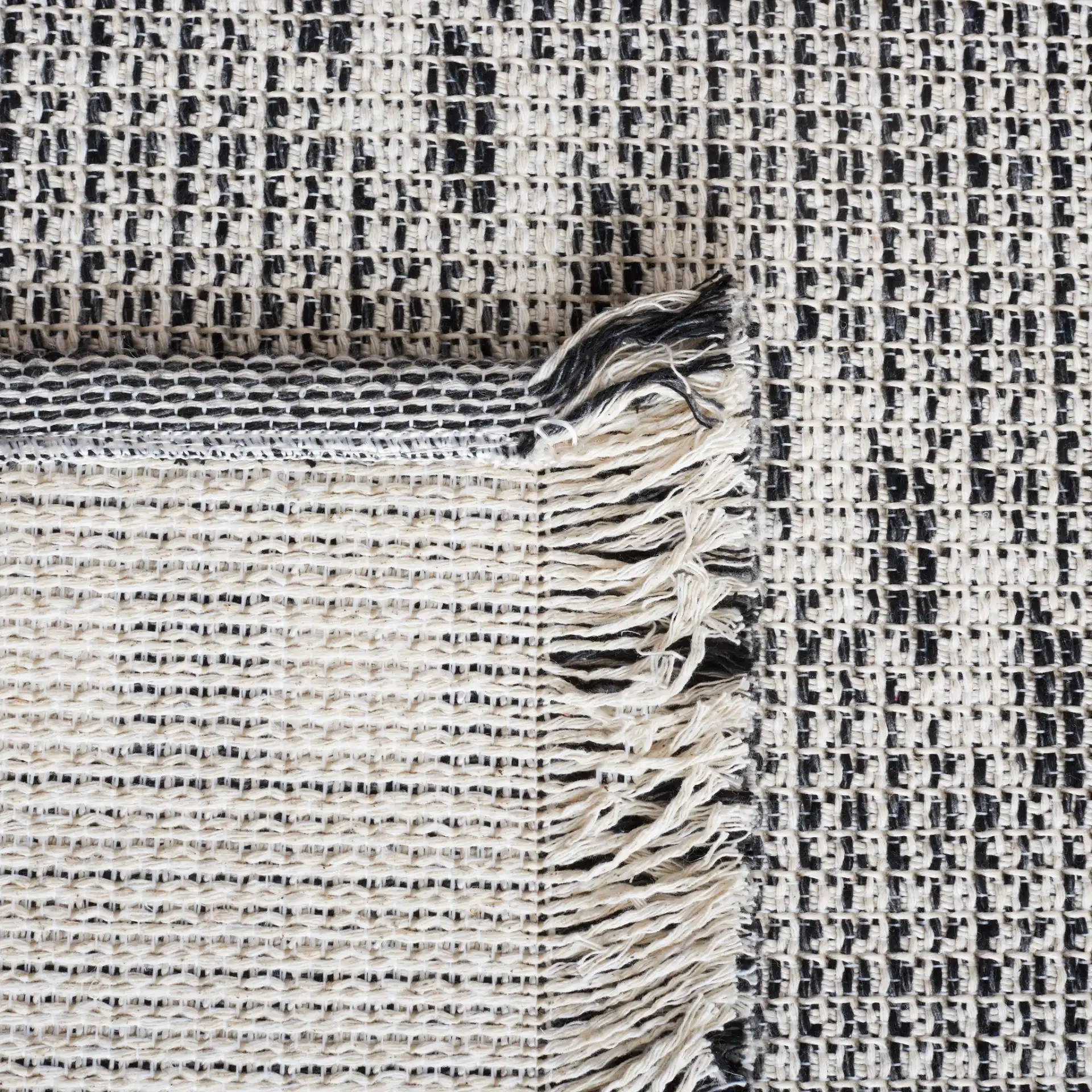 Augustine Large Scale Diamond Rug in Ivory / Black in a styled room