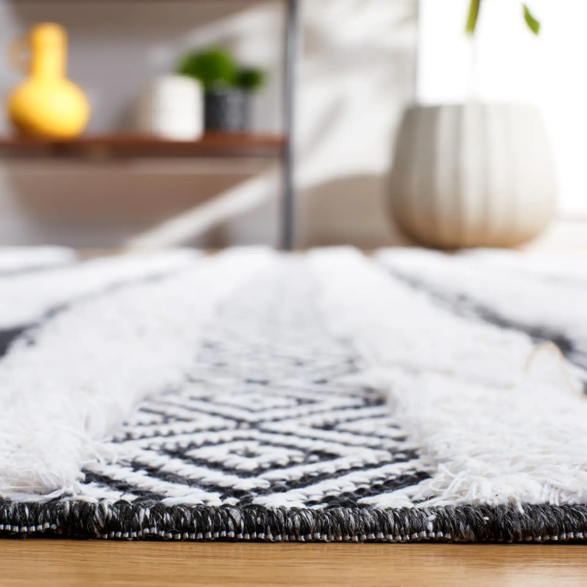 Augustine Banded Chevron Rug in Black / Ivory in a styled room
