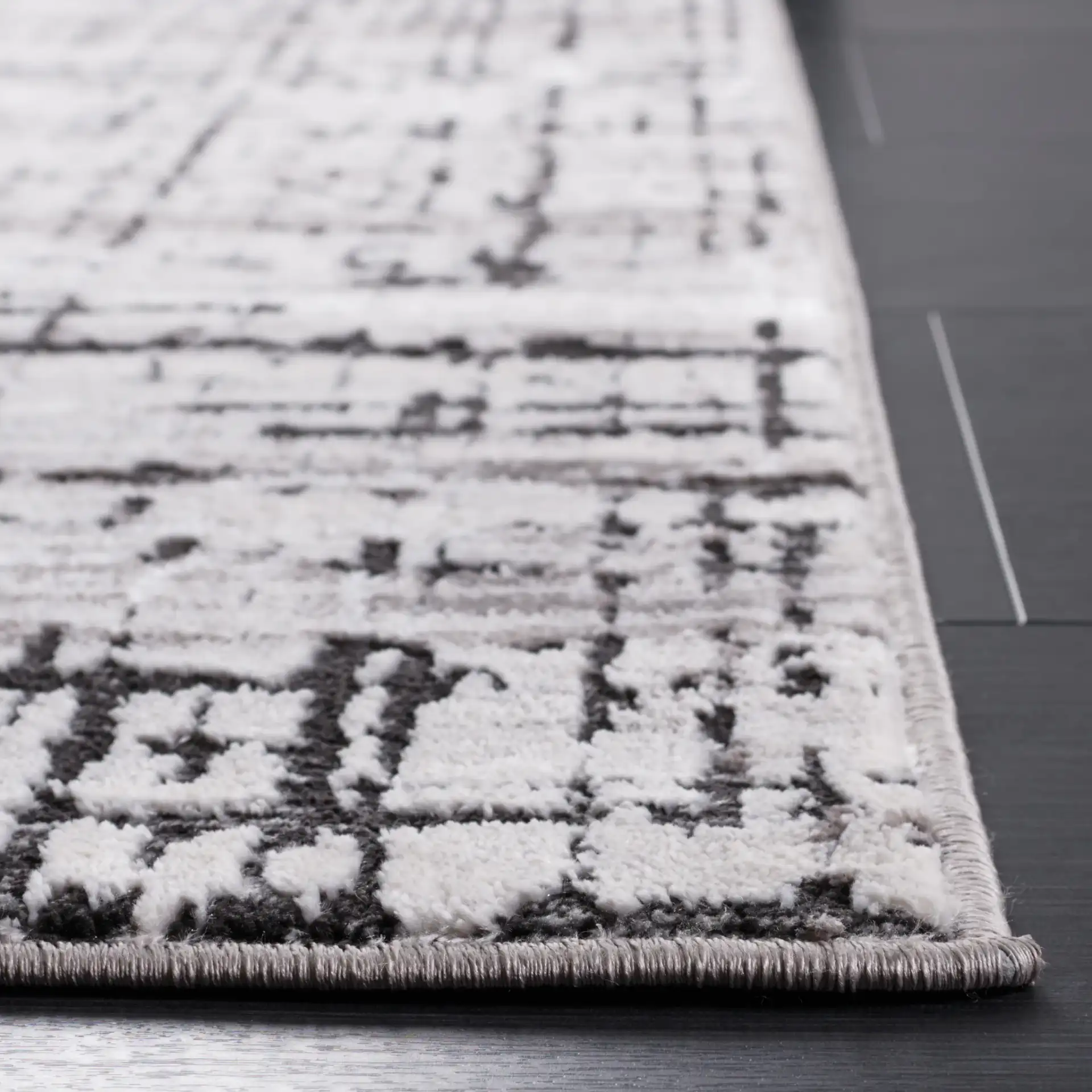 Amelia Distressed Grid Rug in Gray / Charcoal in a styled room