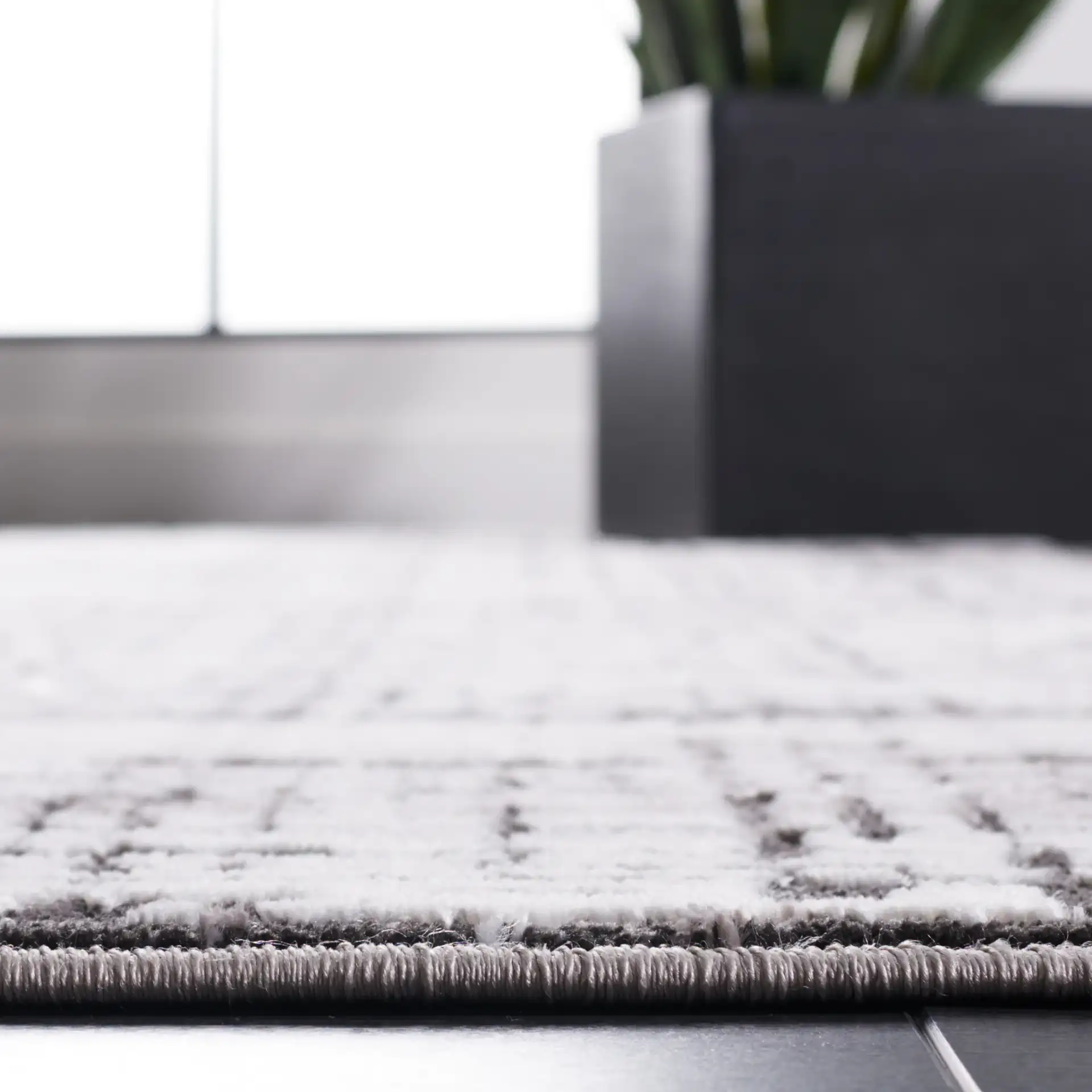 Amelia Distressed Grid Rug in Gray / Charcoal in a styled room