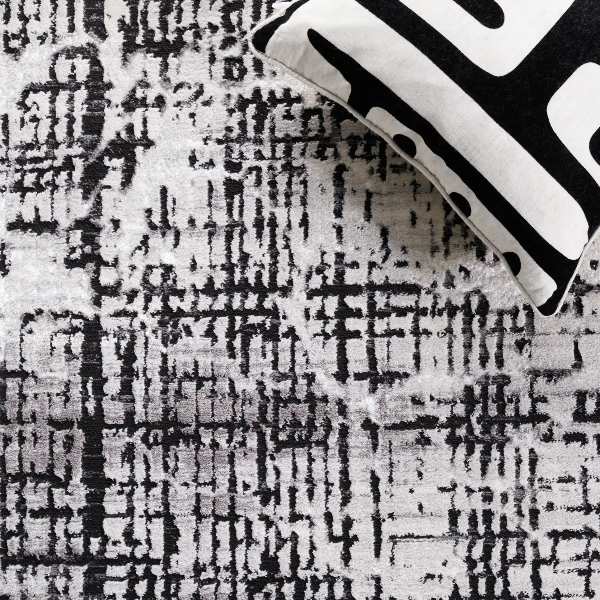 Amelia Distressed Grid Rug in Gray / Charcoal in a styled room