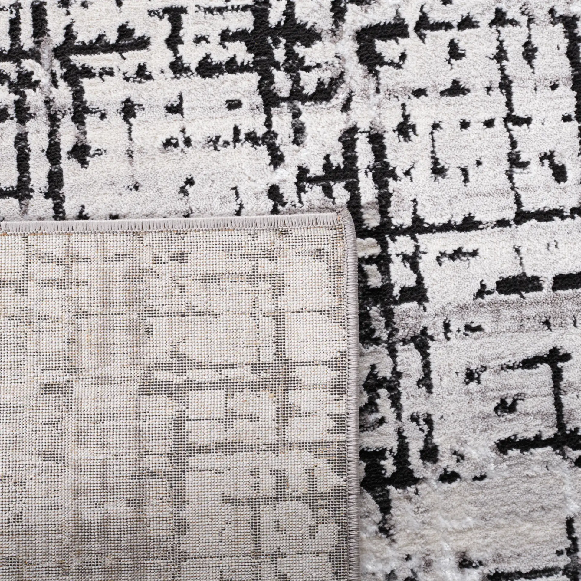 Amelia Distressed Grid Rug in Gray / Charcoal in a styled room