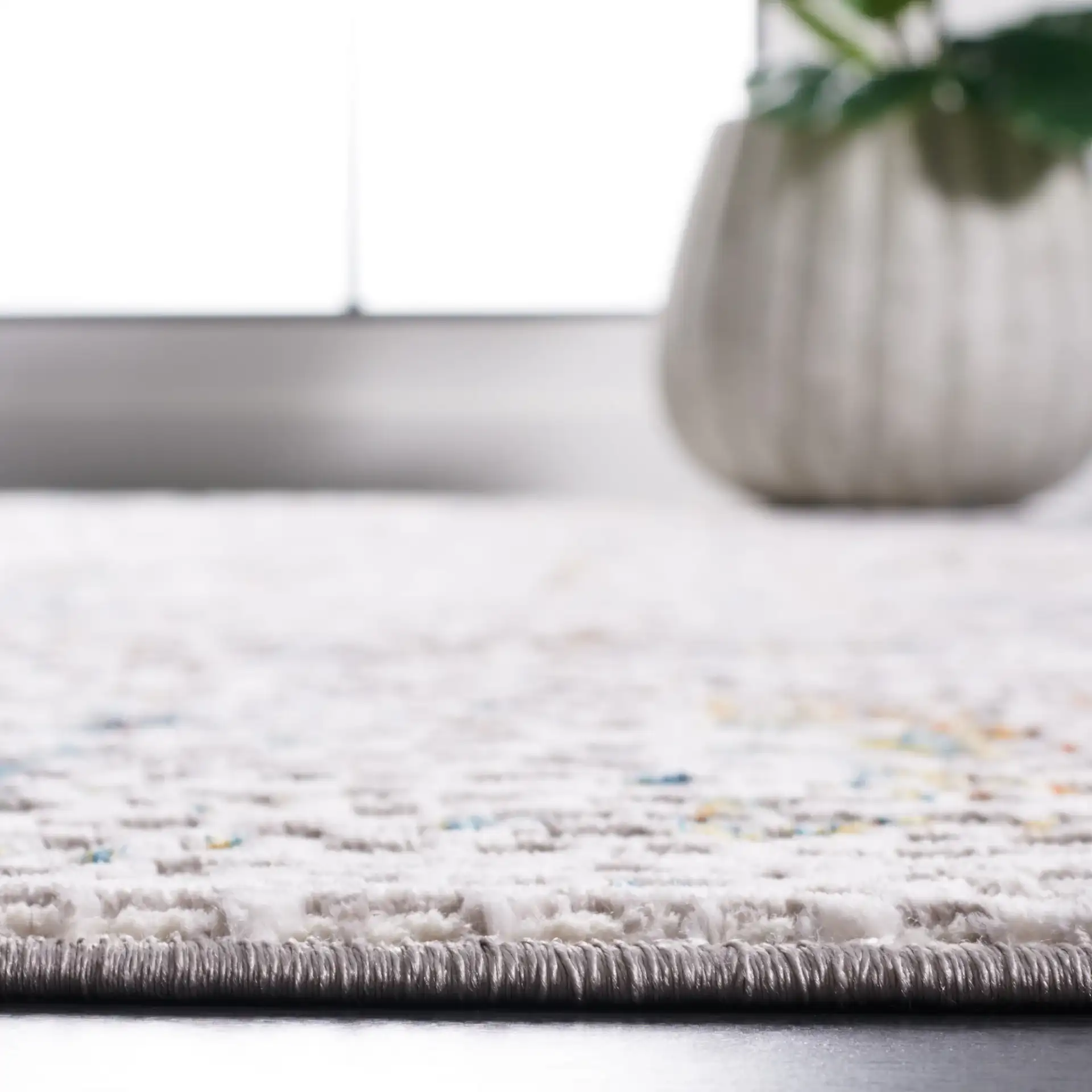 Amelia Textured Abstract Rug in Gray / Light Gray in a styled room