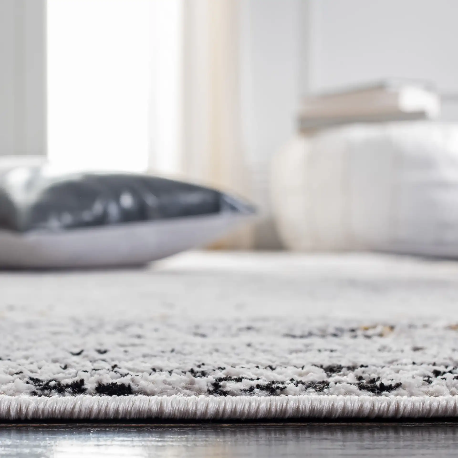 Amelia Distressed Border Rug in Gray / Gold in a styled room