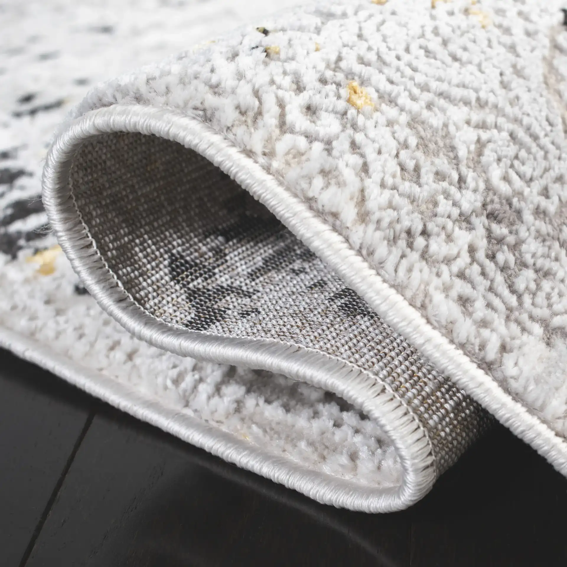 Amelia Distressed Border Rug in Gray / Gold in a styled room