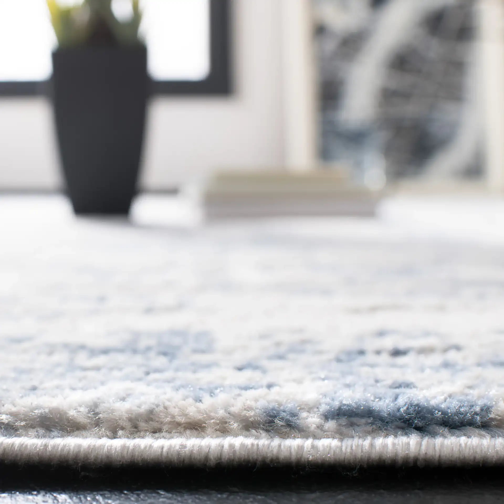 Amelia Distressed Abstract Rug in Ivory / Blue in a styled room