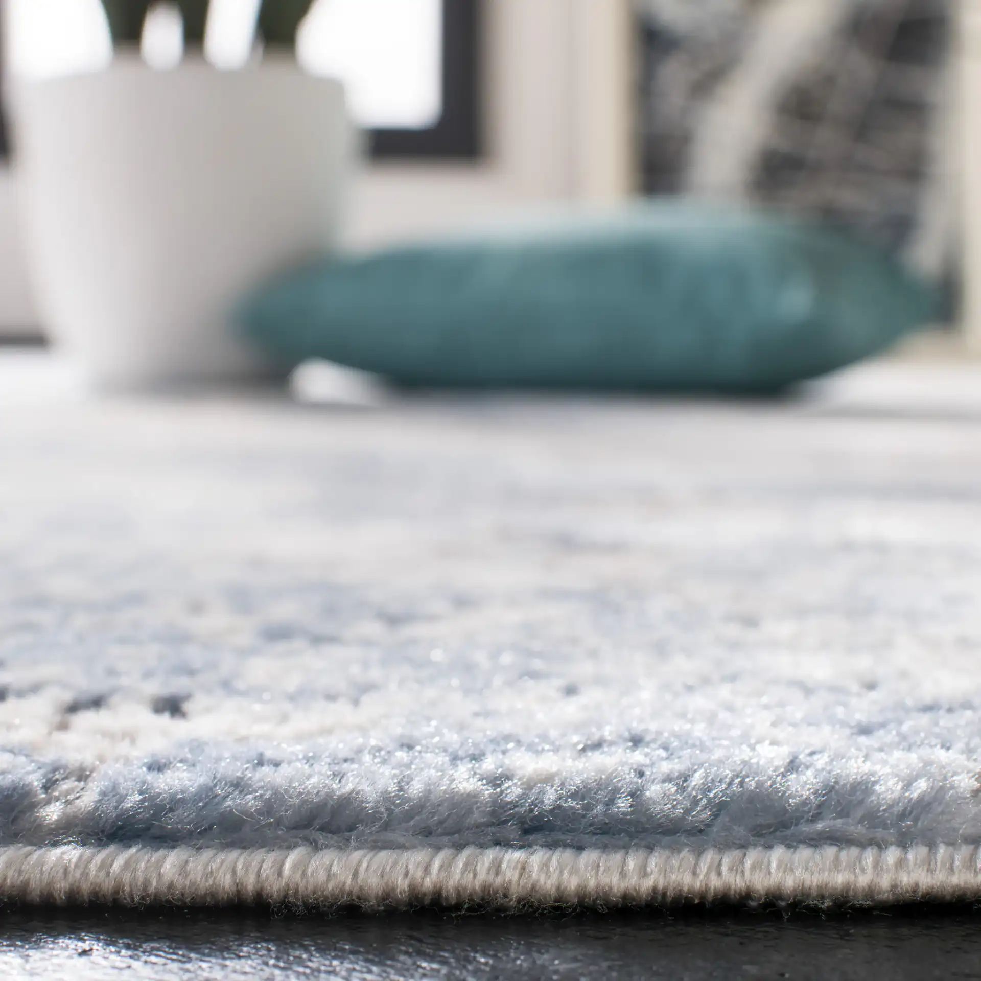 Amelia Clouded Abstract Rug in Gray / Blue in a styled room