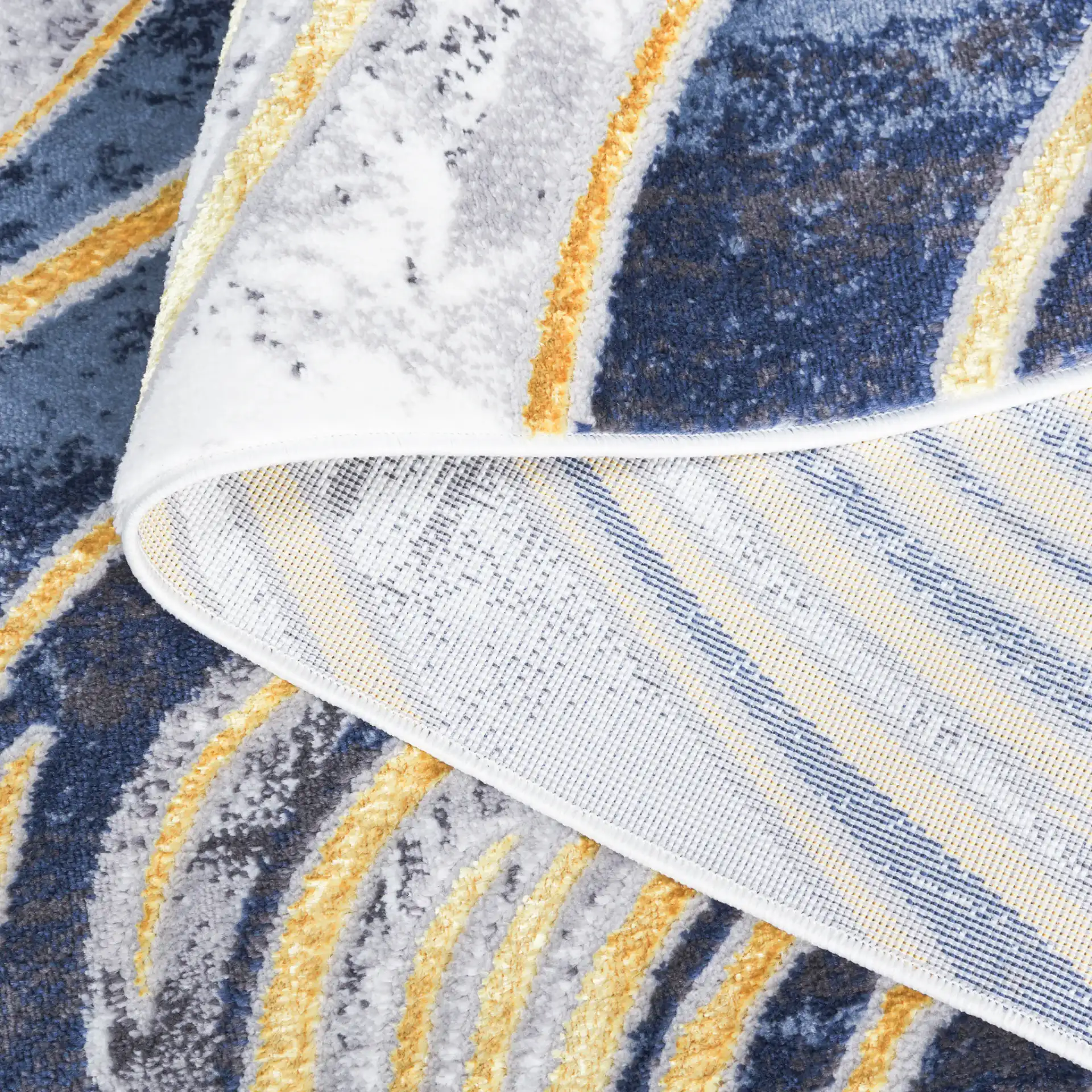 Amelia Abstract Waves Rug in Blue / Gold in a styled room