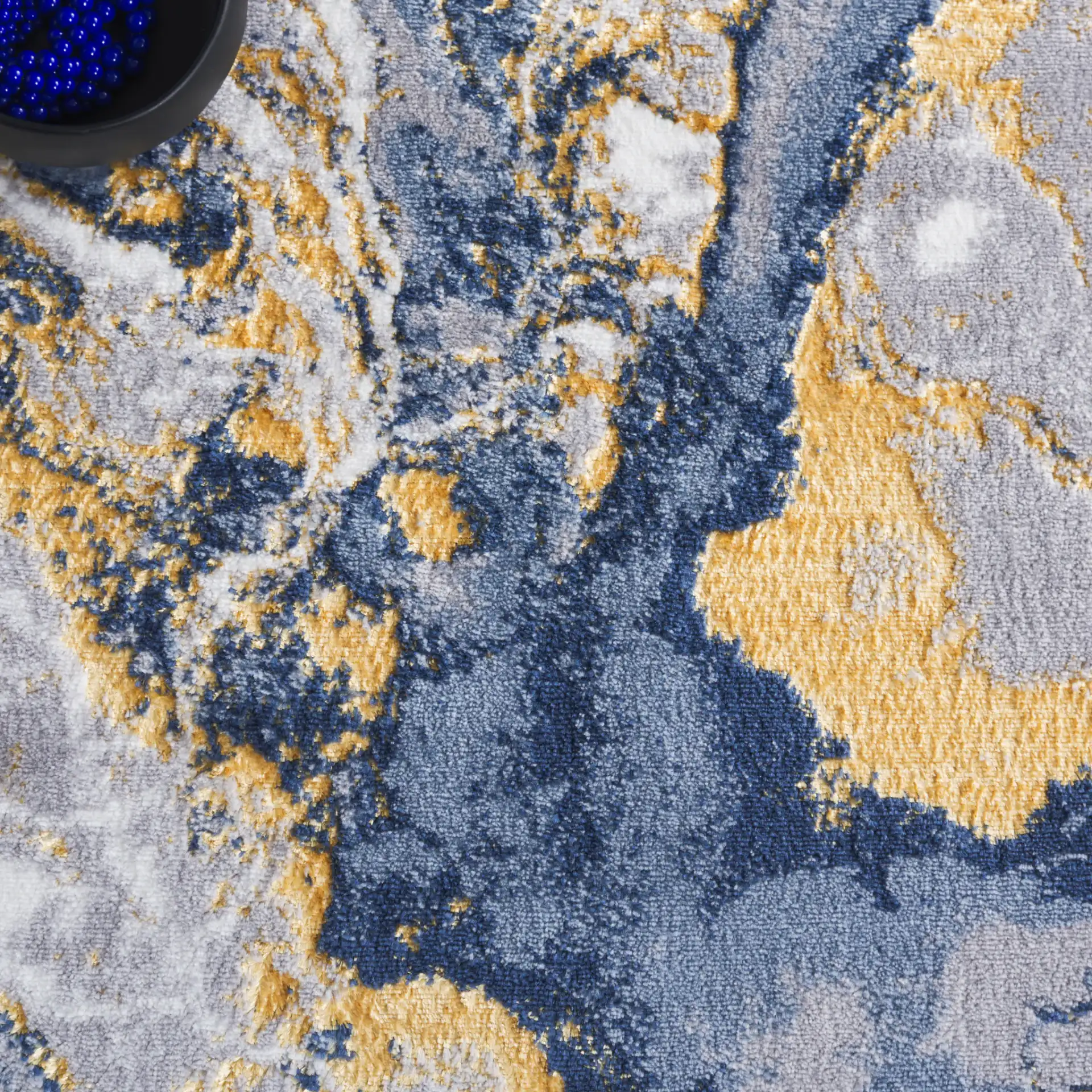Amelia Geode Abstract Rug in Blue / Gold in a styled room