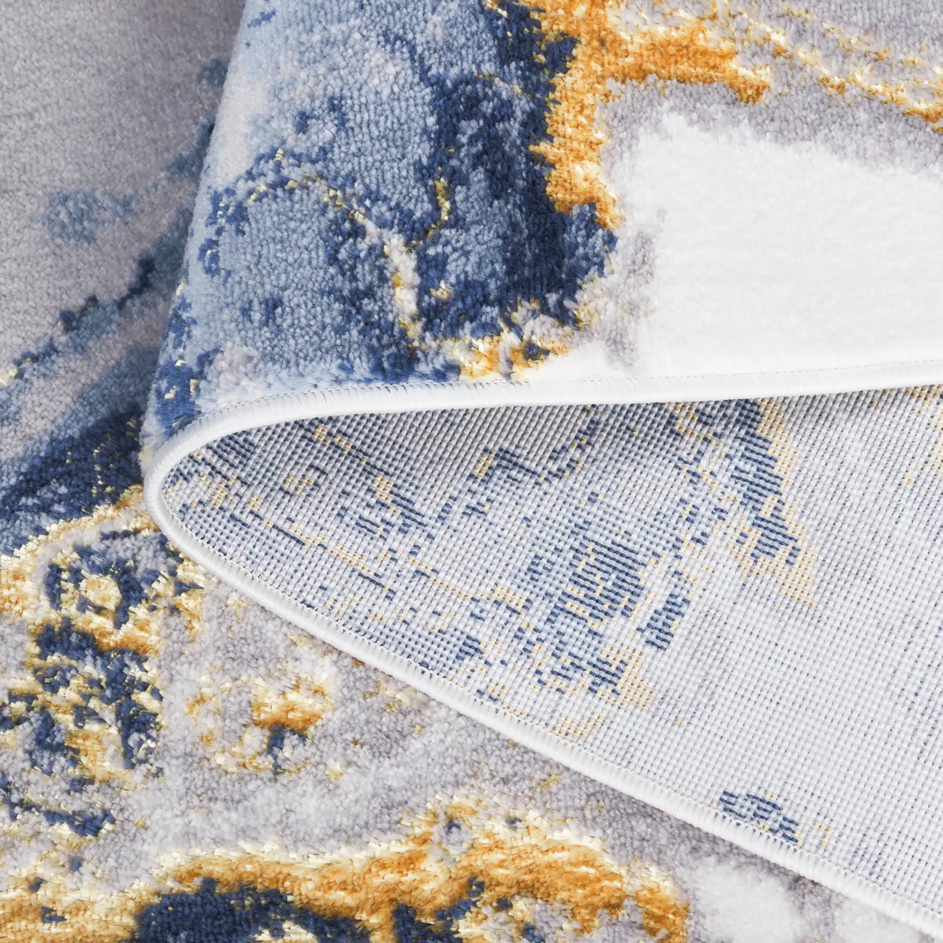 Amelia Geode Abstract Rug in Blue / Gold in a styled room