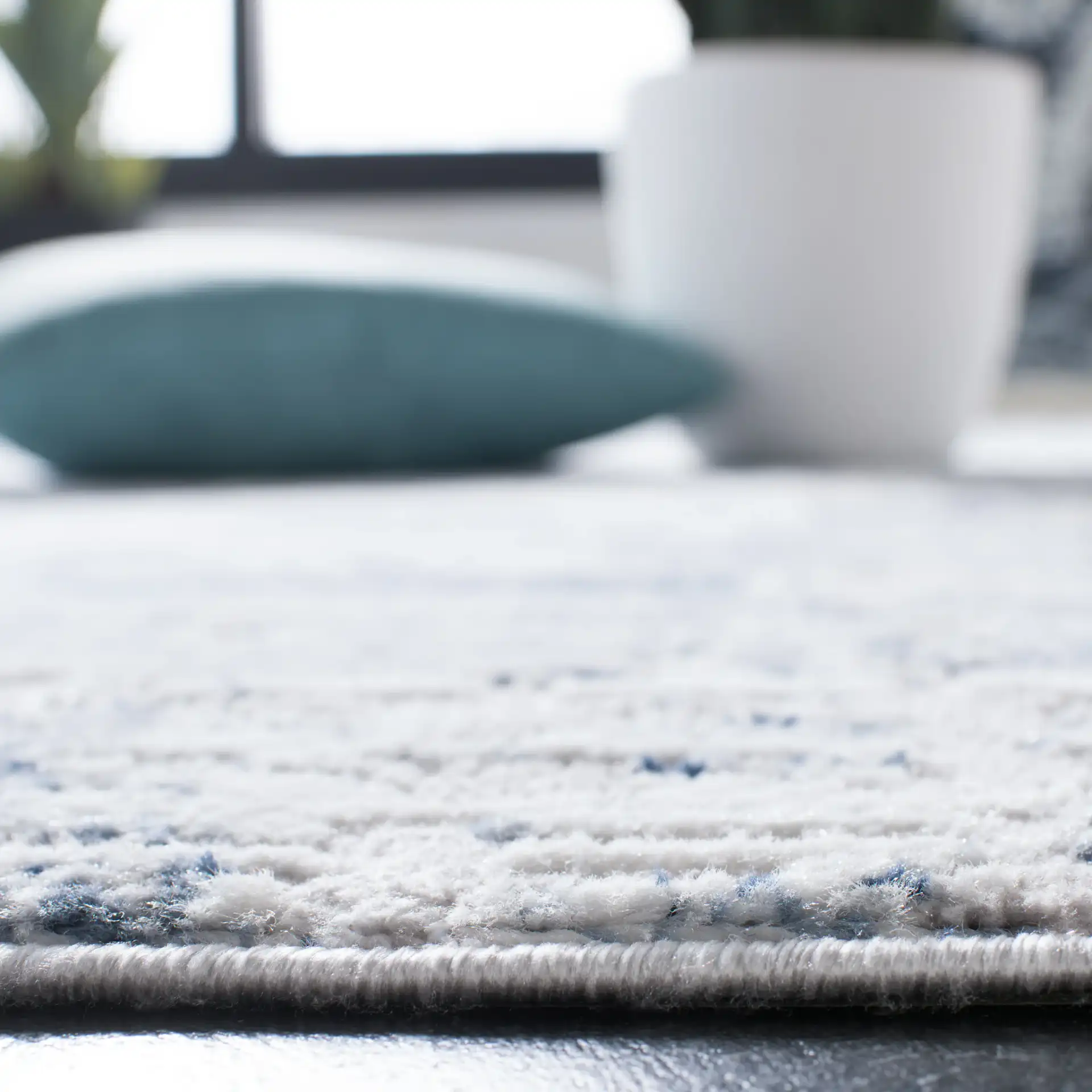 Amelia Abstract Grid Rug in Blue / Gray in a styled room