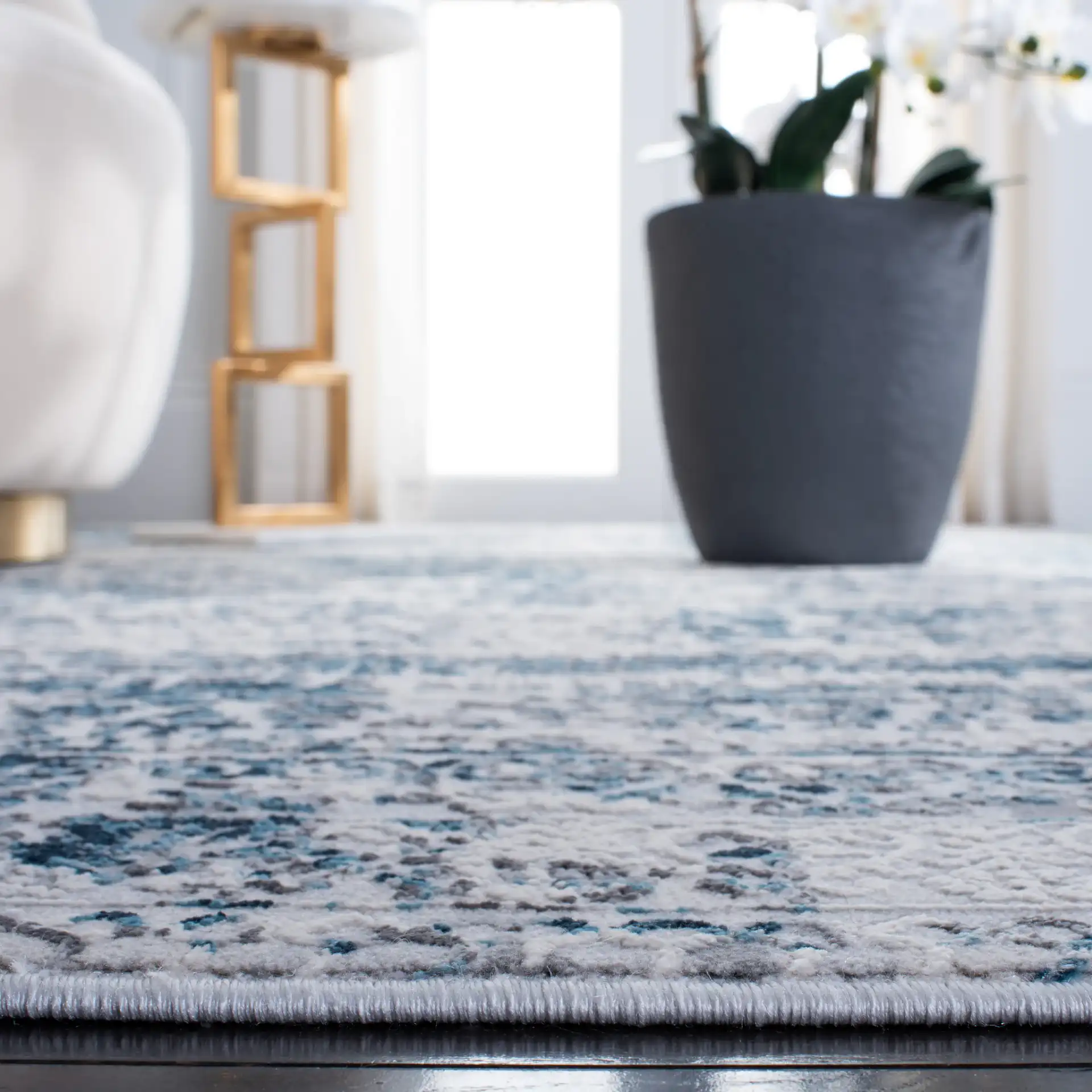 Alhambra Distressed Bordered Rug in Cream / Turquoise in a styled room