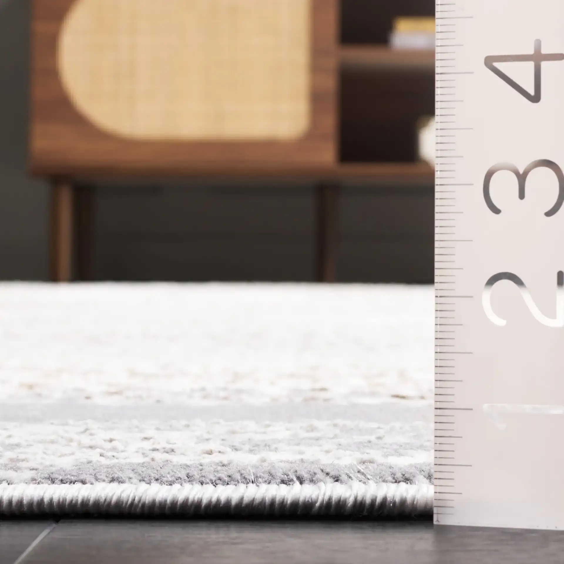 Alenia Distressed Lattice Border Rug in Ivory / Gray in a styled room