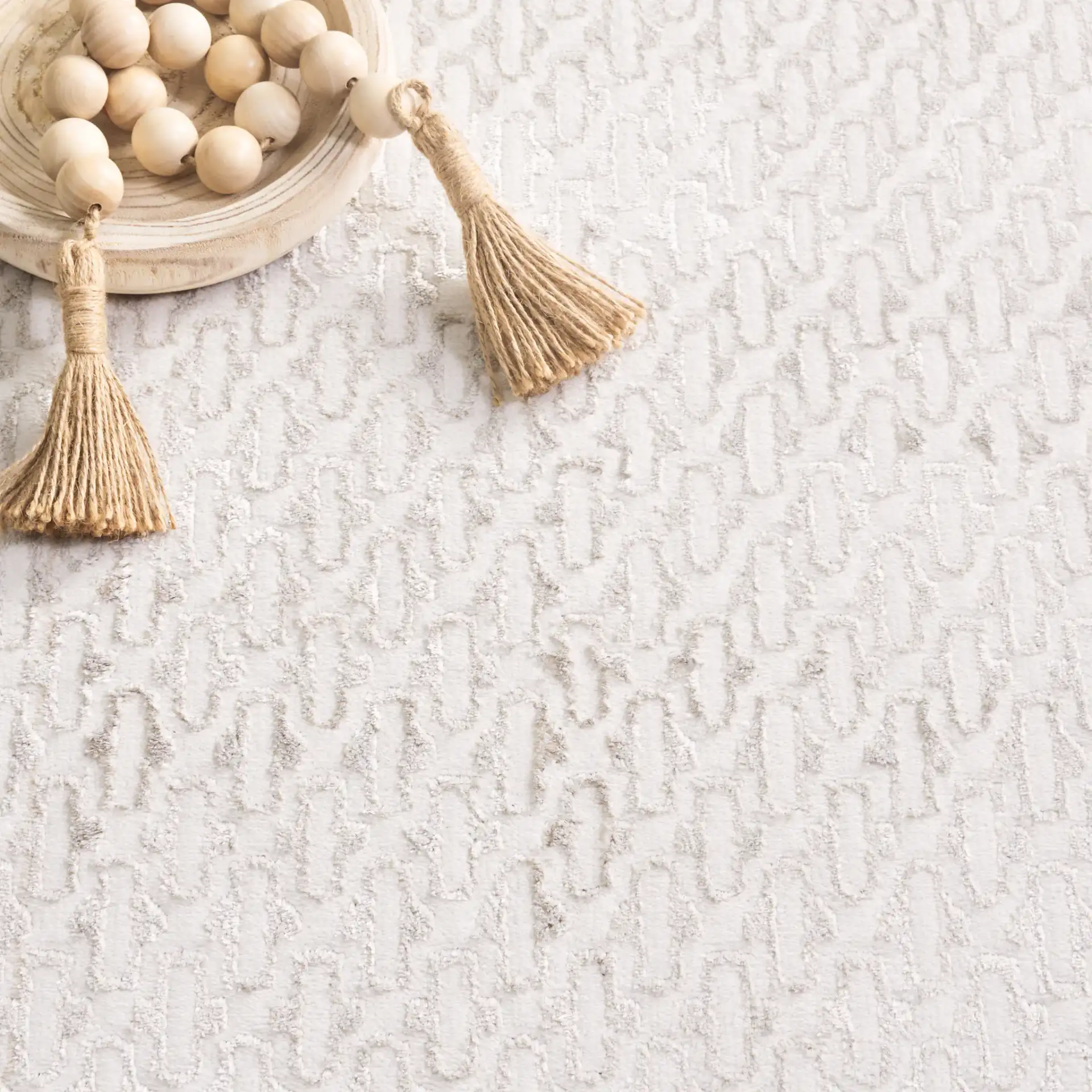 Alenia Distressed Lattice Border Rug in Ivory / Gray in a styled room