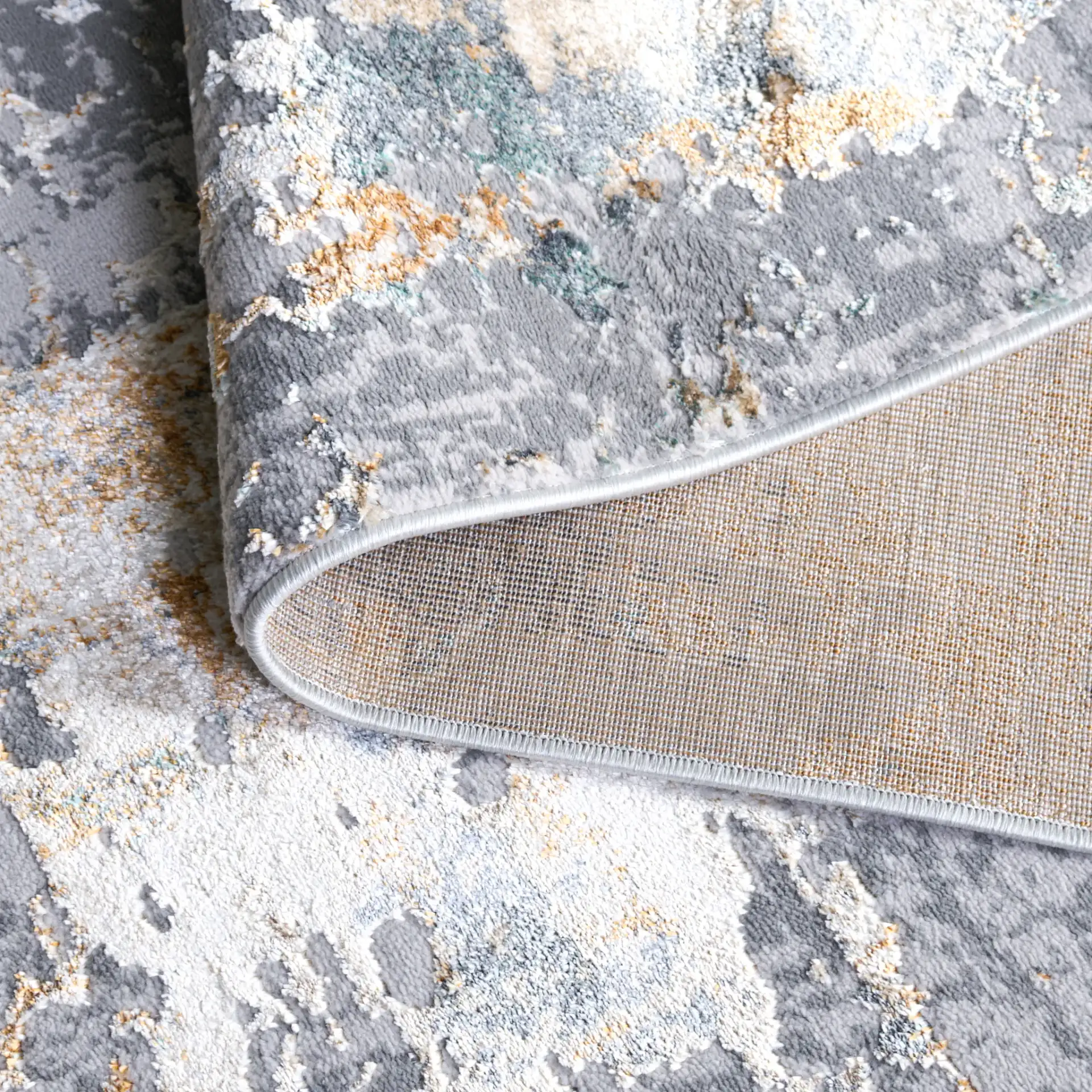Alenia Mottled Abstract Rug in Gray / Beige in a styled room