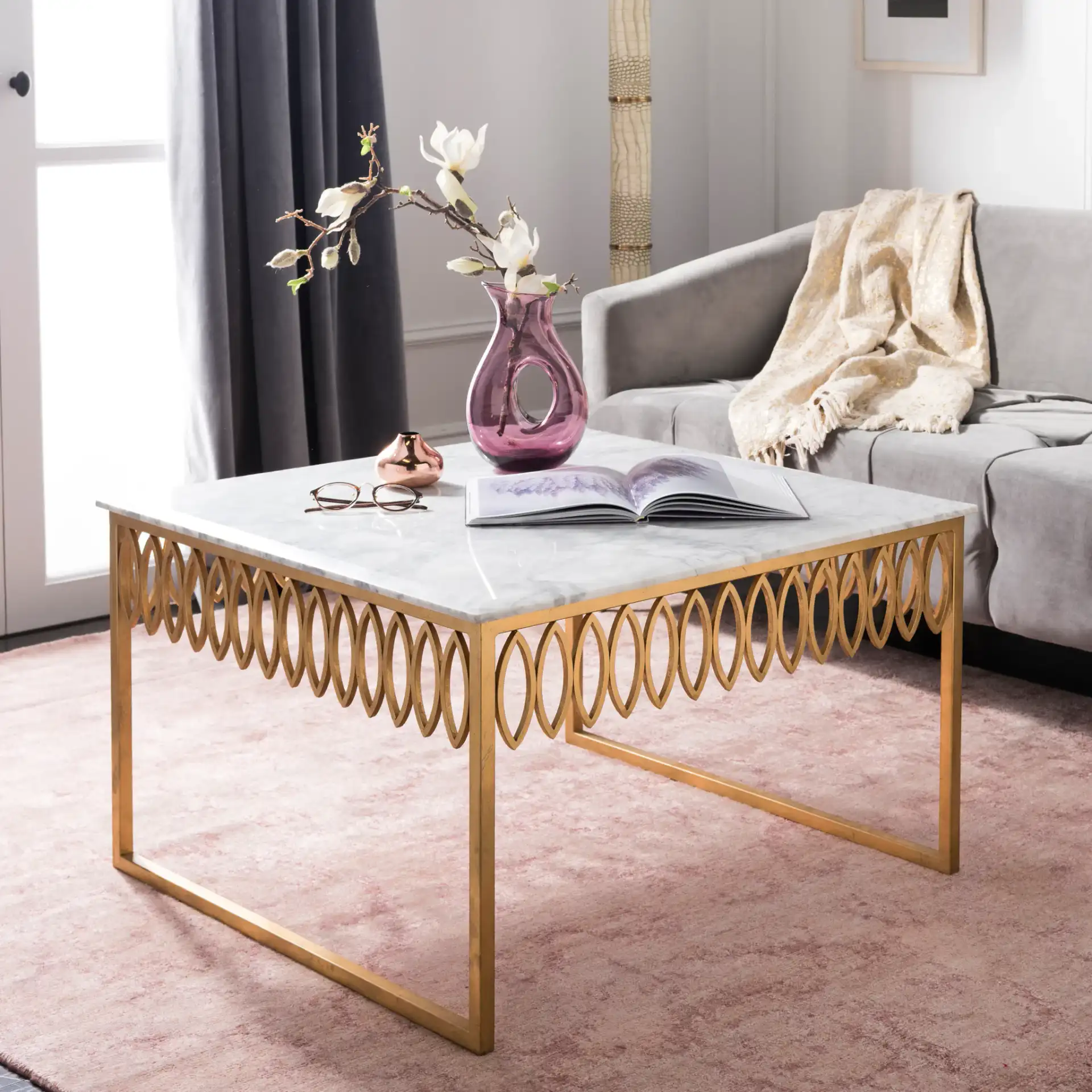 Natalia Cocktail Table in Gold / White in a styled room
