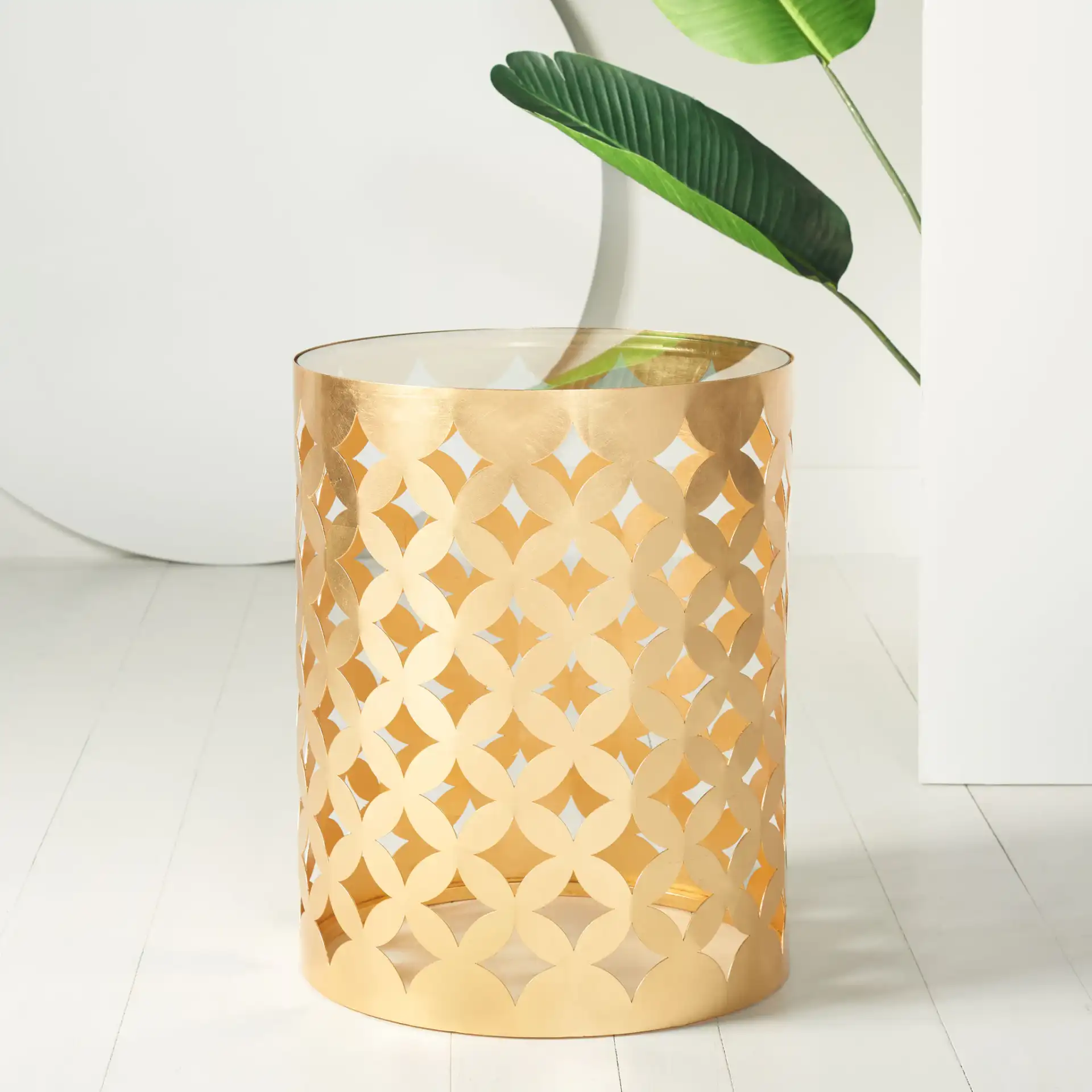 Cairo Round Gold Leaf End Table in Gold in a styled room