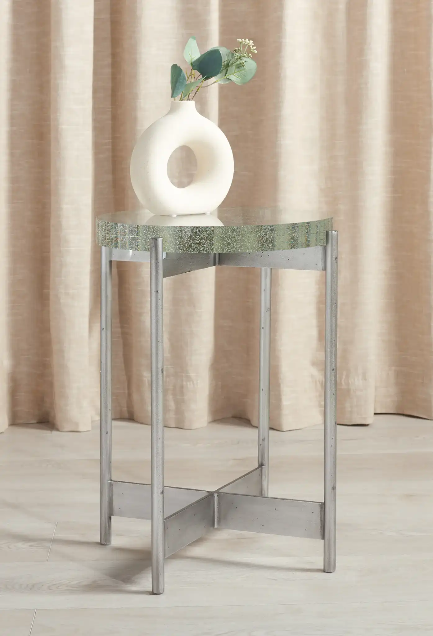 Adriella Round Bubble Glass Table in Silver / Clear in a styled room