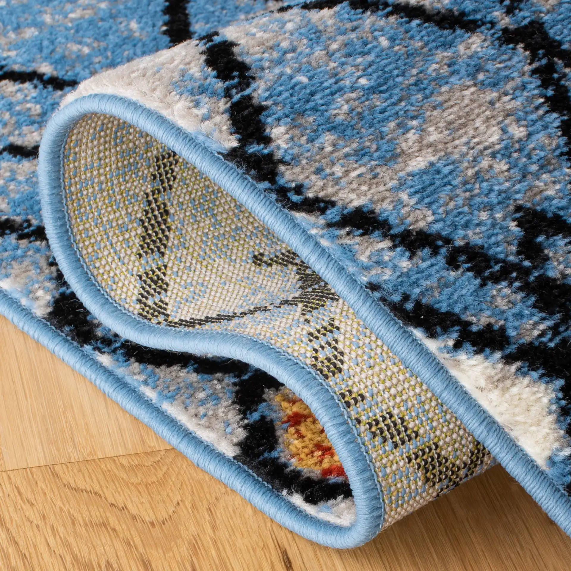 Amsterdam Banded Diamond Rug in Blue / Ivory in a styled room