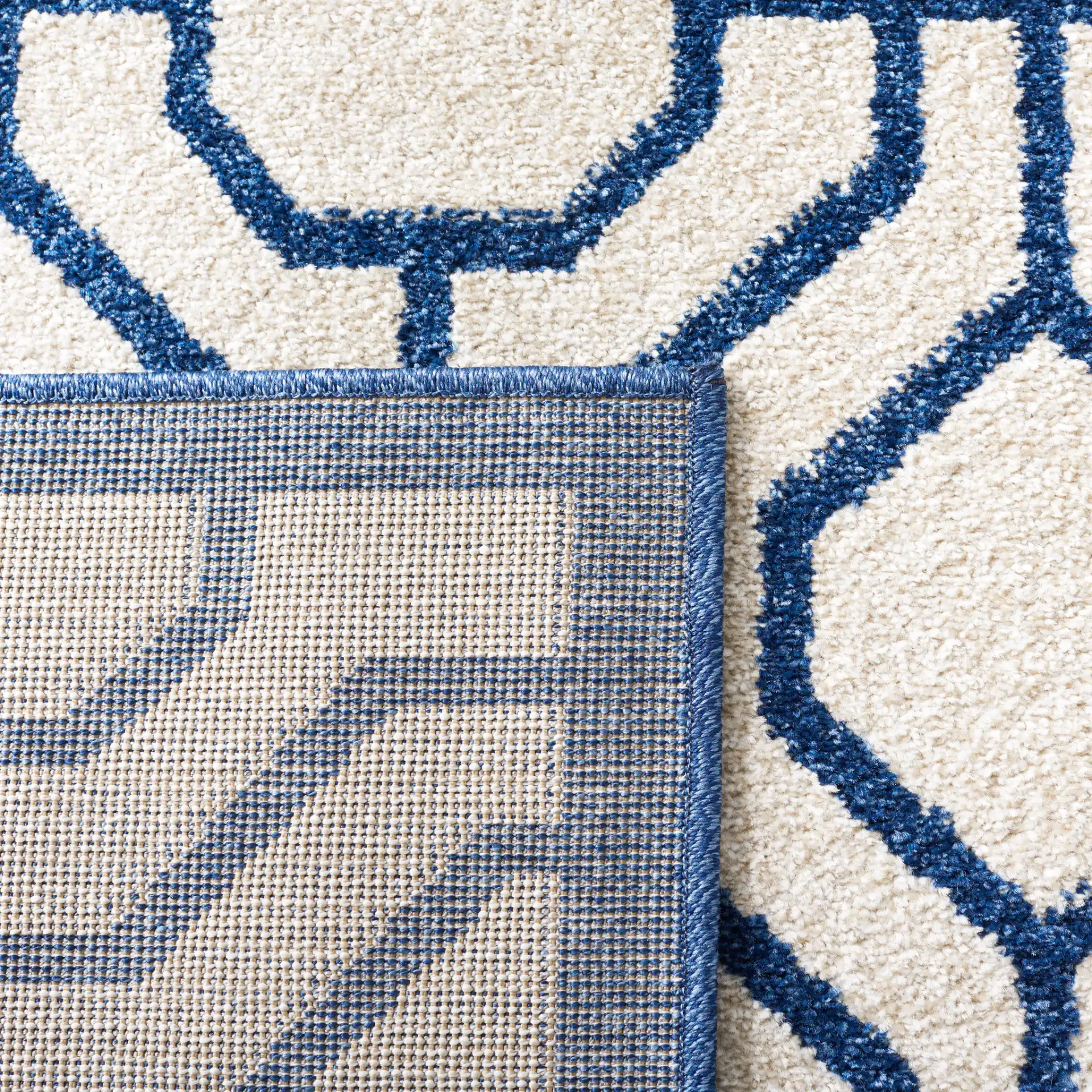 Amherst Interlocking Lattice Rug in Ivory / Navy in a styled room