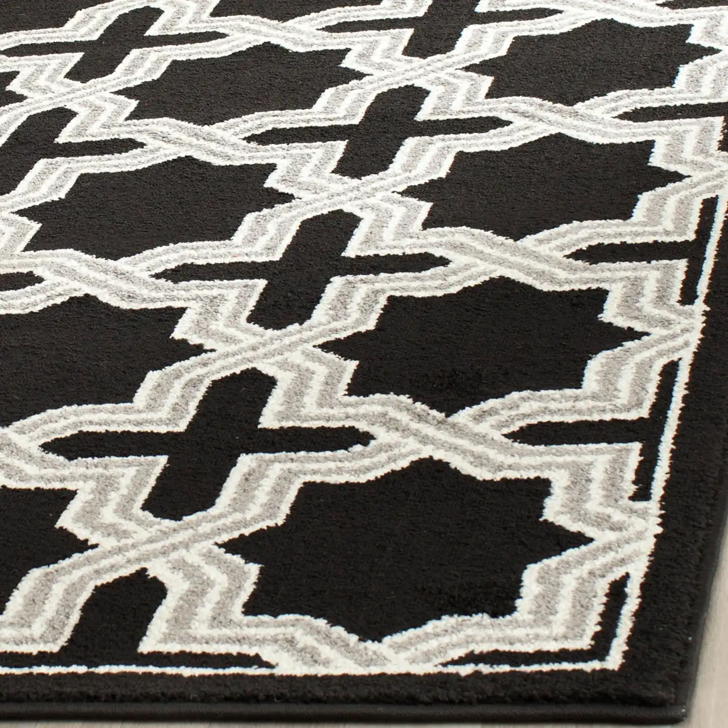 Amherst Interlocking Trellis Rug in Anthracite / Gray in a styled room