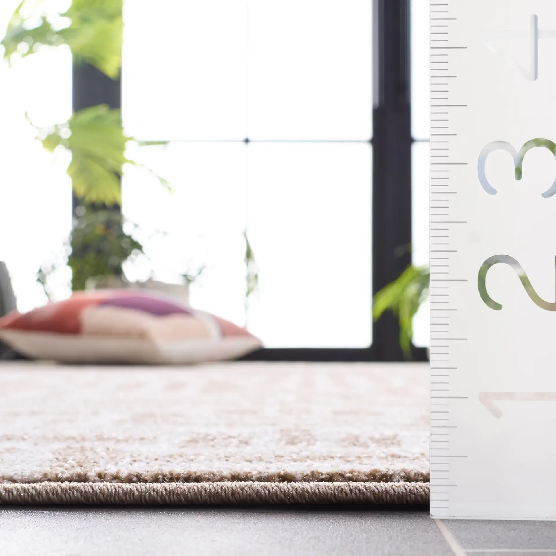 Amherst Interlocking Maze Rug in Beige / Cream in a styled room