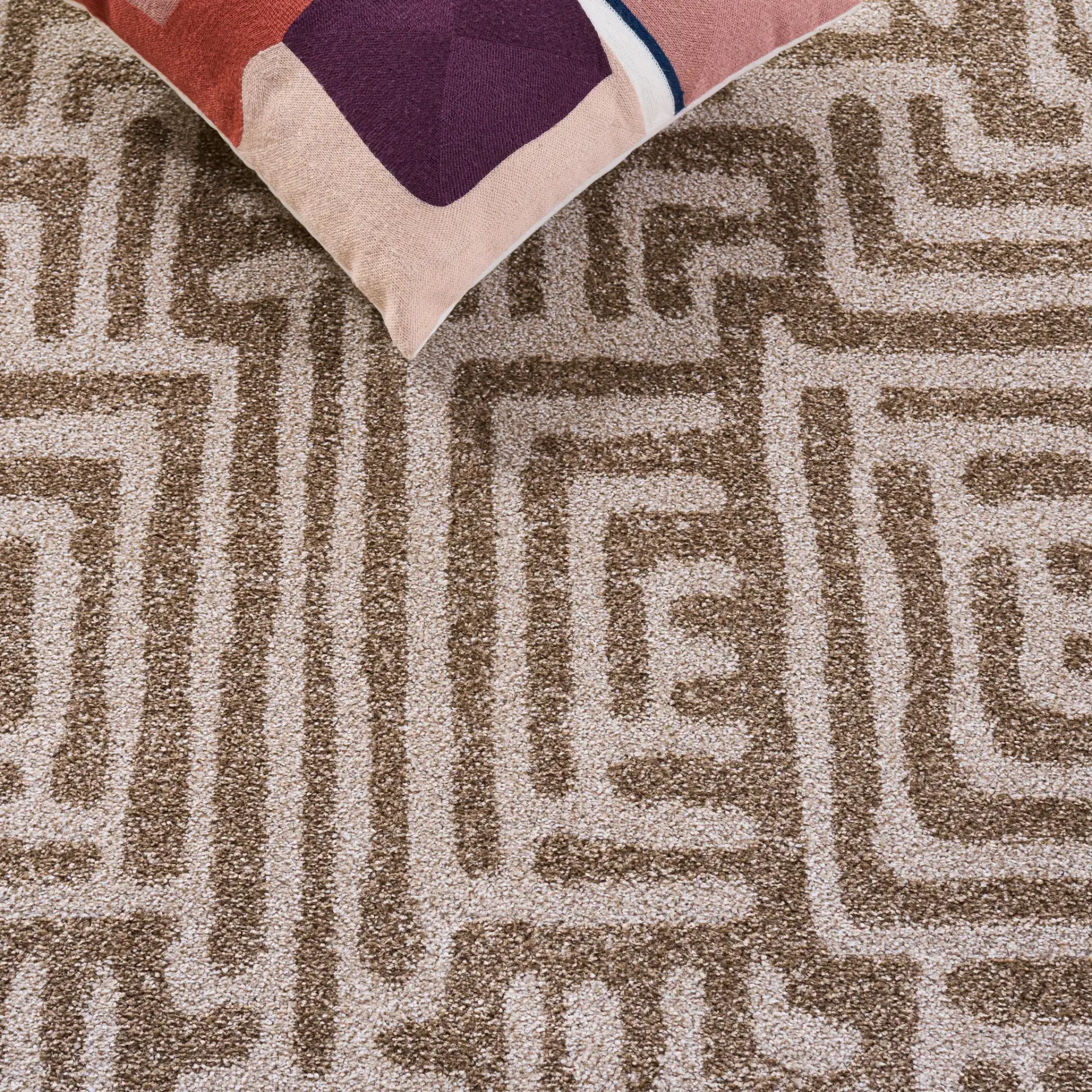 Amherst Interlocking Maze Rug in Beige / Cream in a styled room