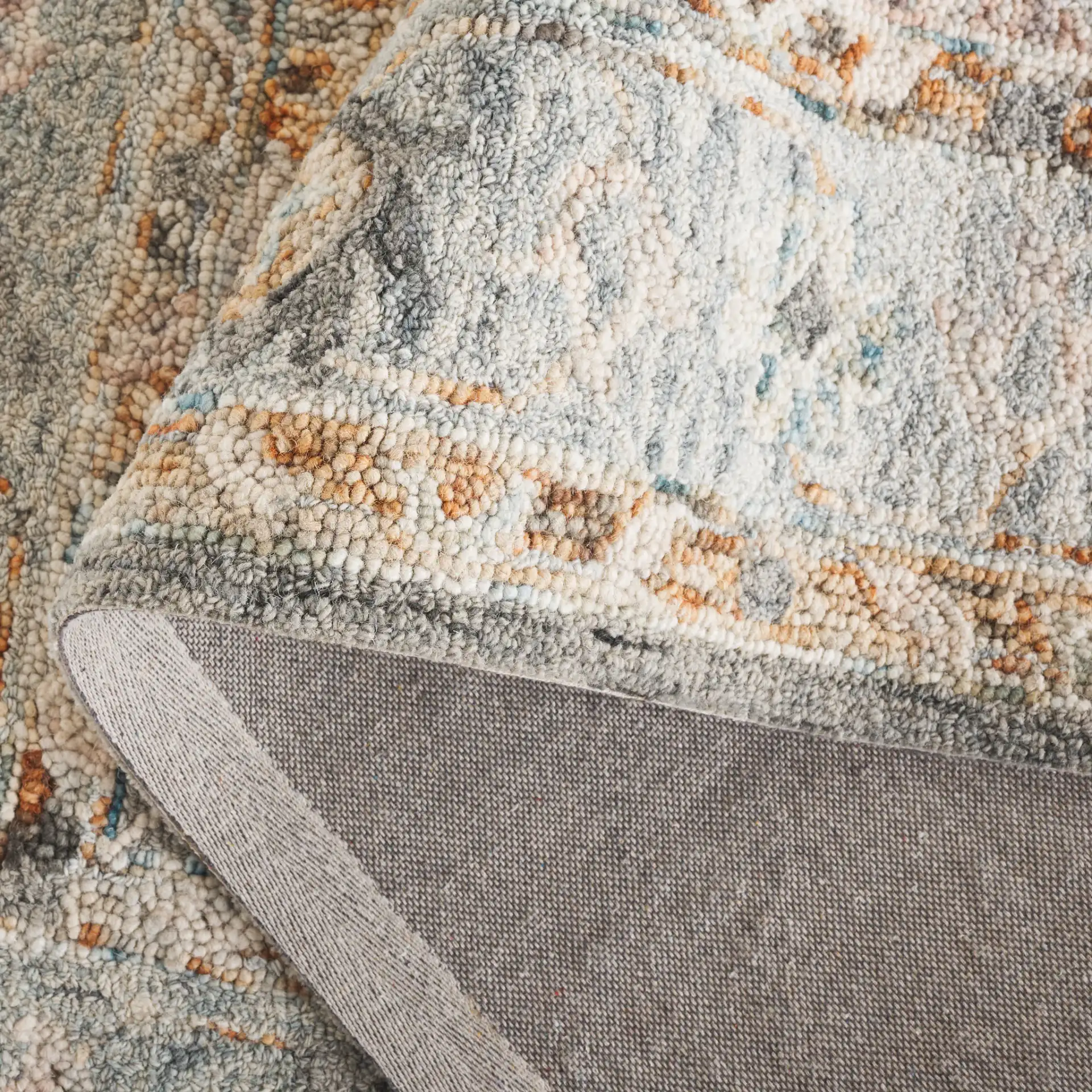 Anatolia Stepped Medallion Hand-Tufted Wool Rug in Gray / Rust in a styled room