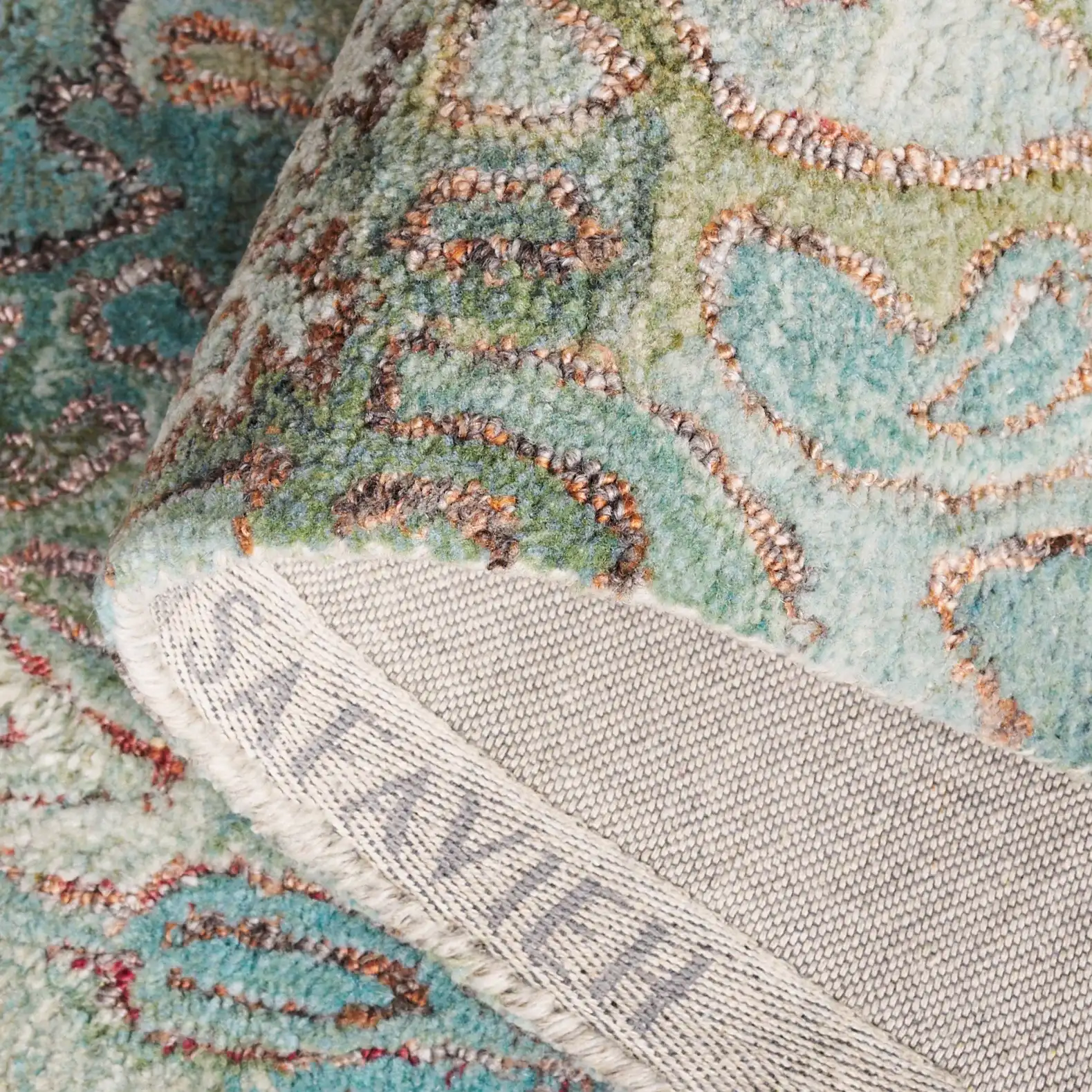 Anatolia Patchwork Hand-Tufted Rug in Teal / Green in a styled room