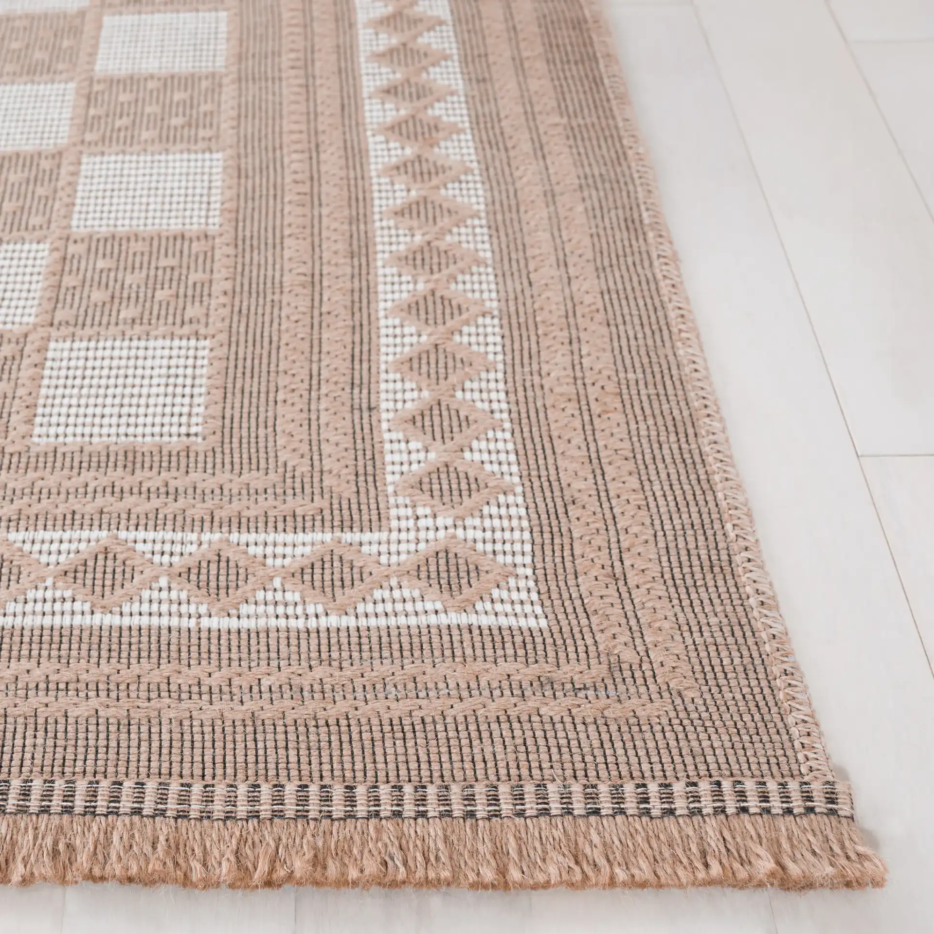 Aspect Bordered Checkerboard Jute Rug in Natural / Ivory in a styled room