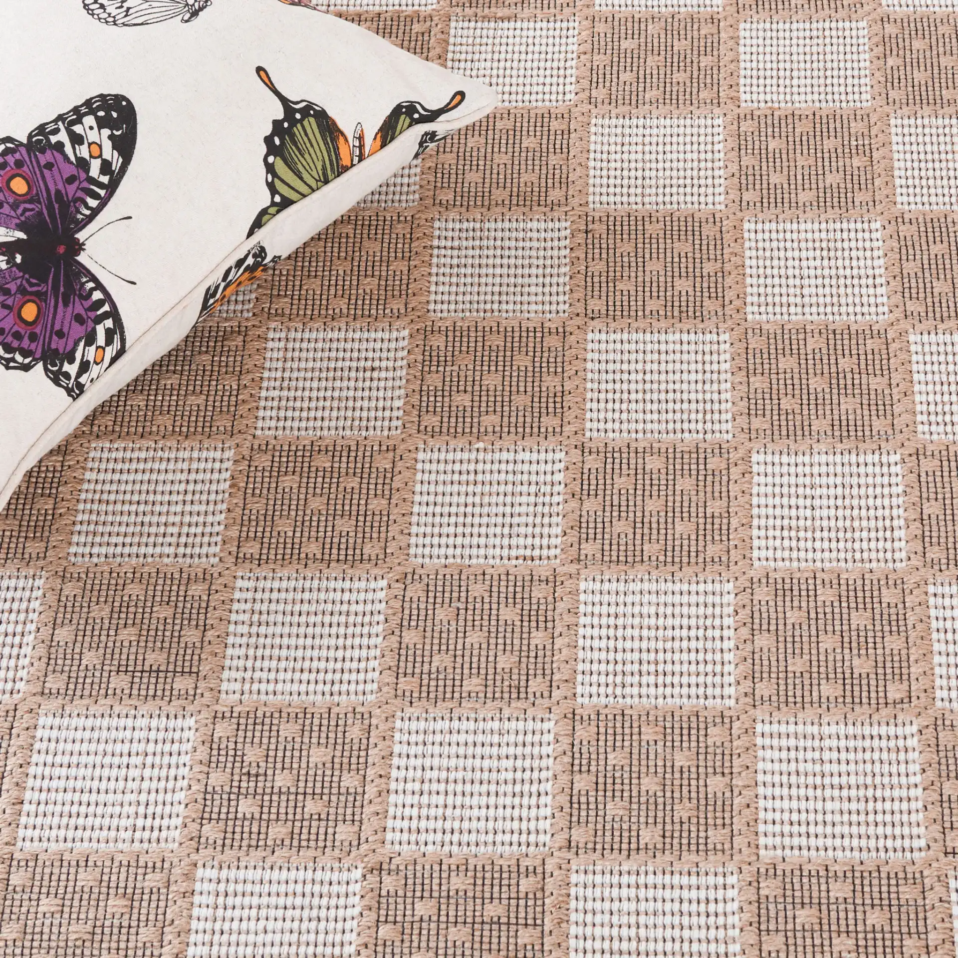 Aspect Bordered Checkerboard Jute Rug in Natural / Ivory in a styled room