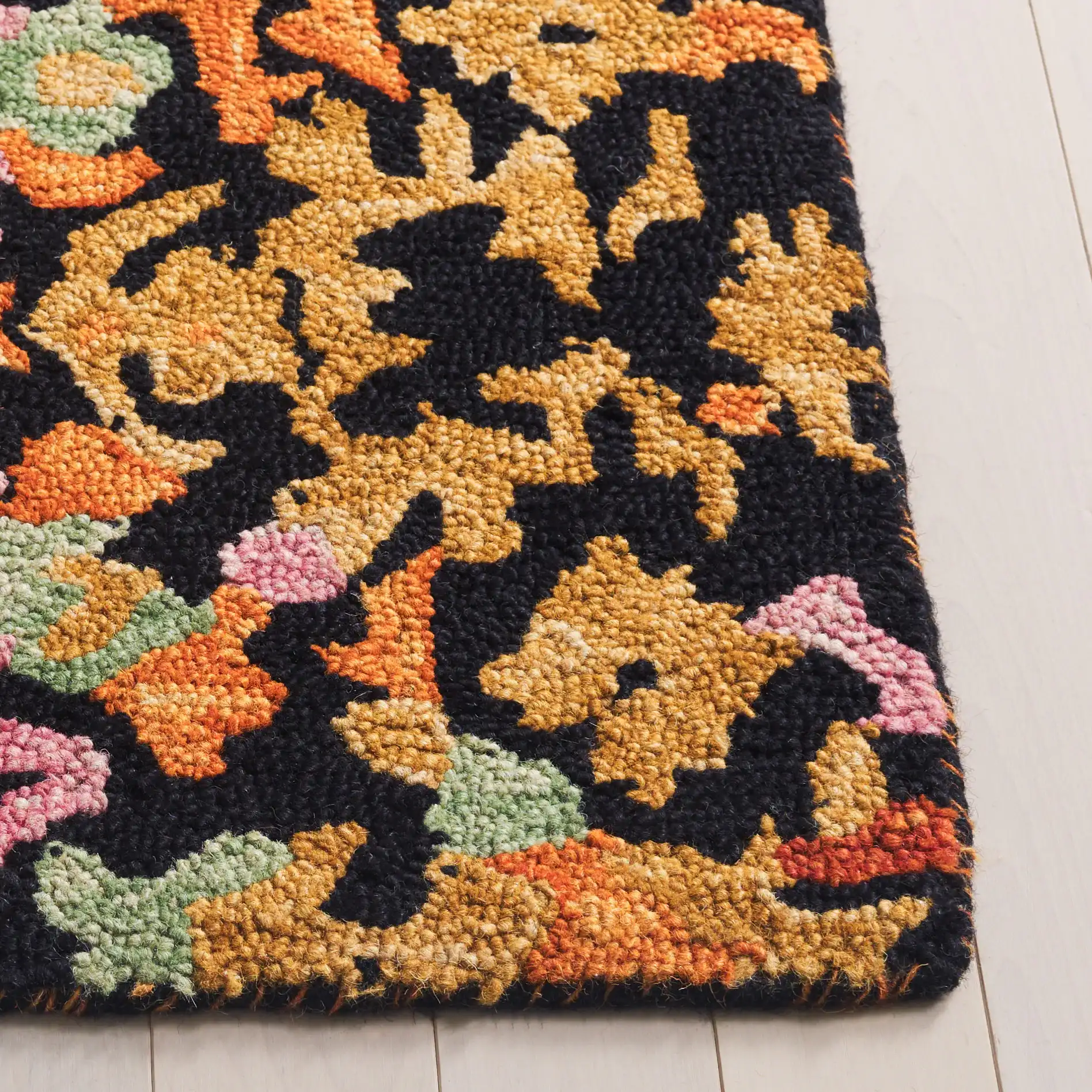 Aspen Mosaic Medallion Hand-Tufted Wool Rug in Black / Rust in a styled room