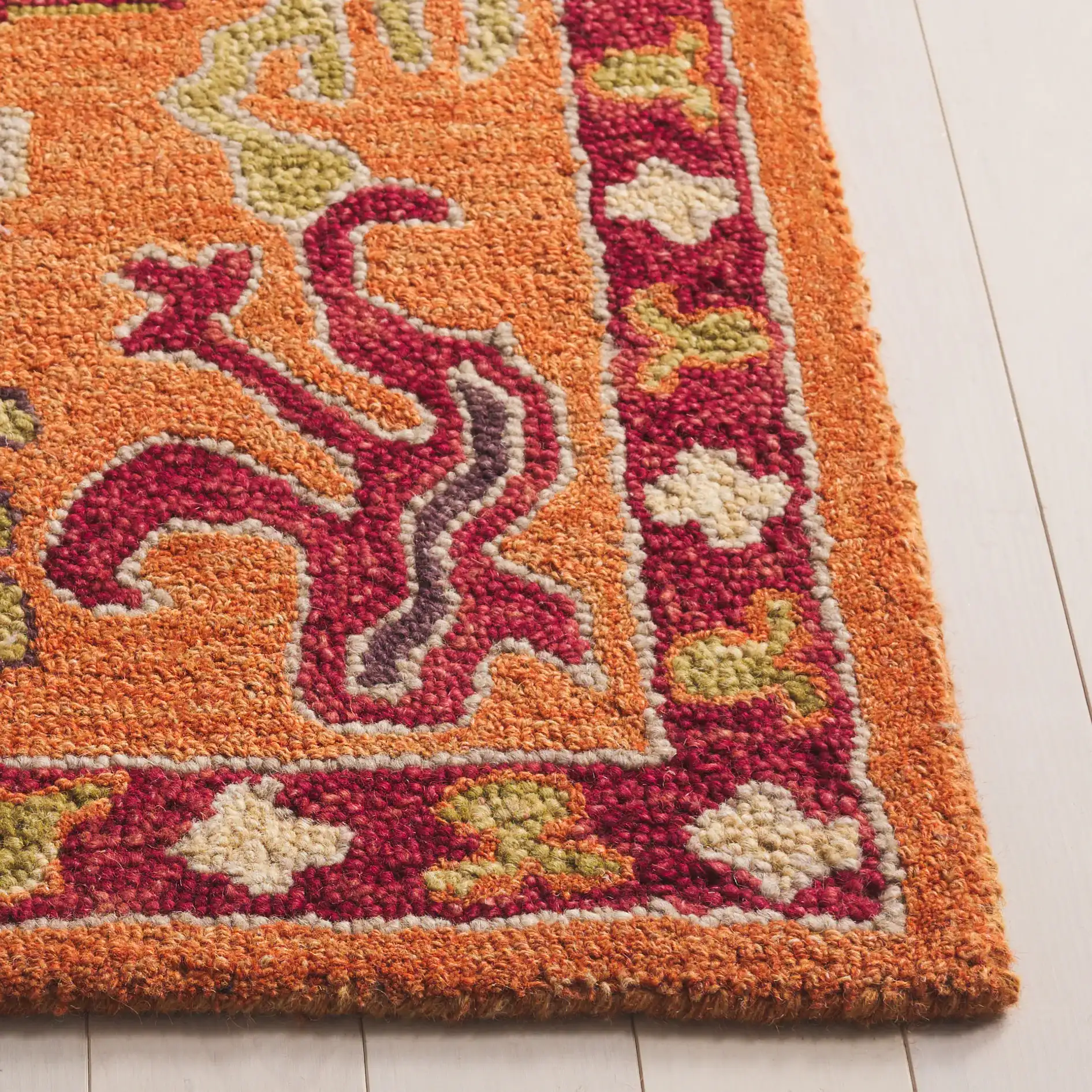 Aspen Tribal Diamond Medallion Hand-Tufted Wool Rug in Rust / Red in a styled room