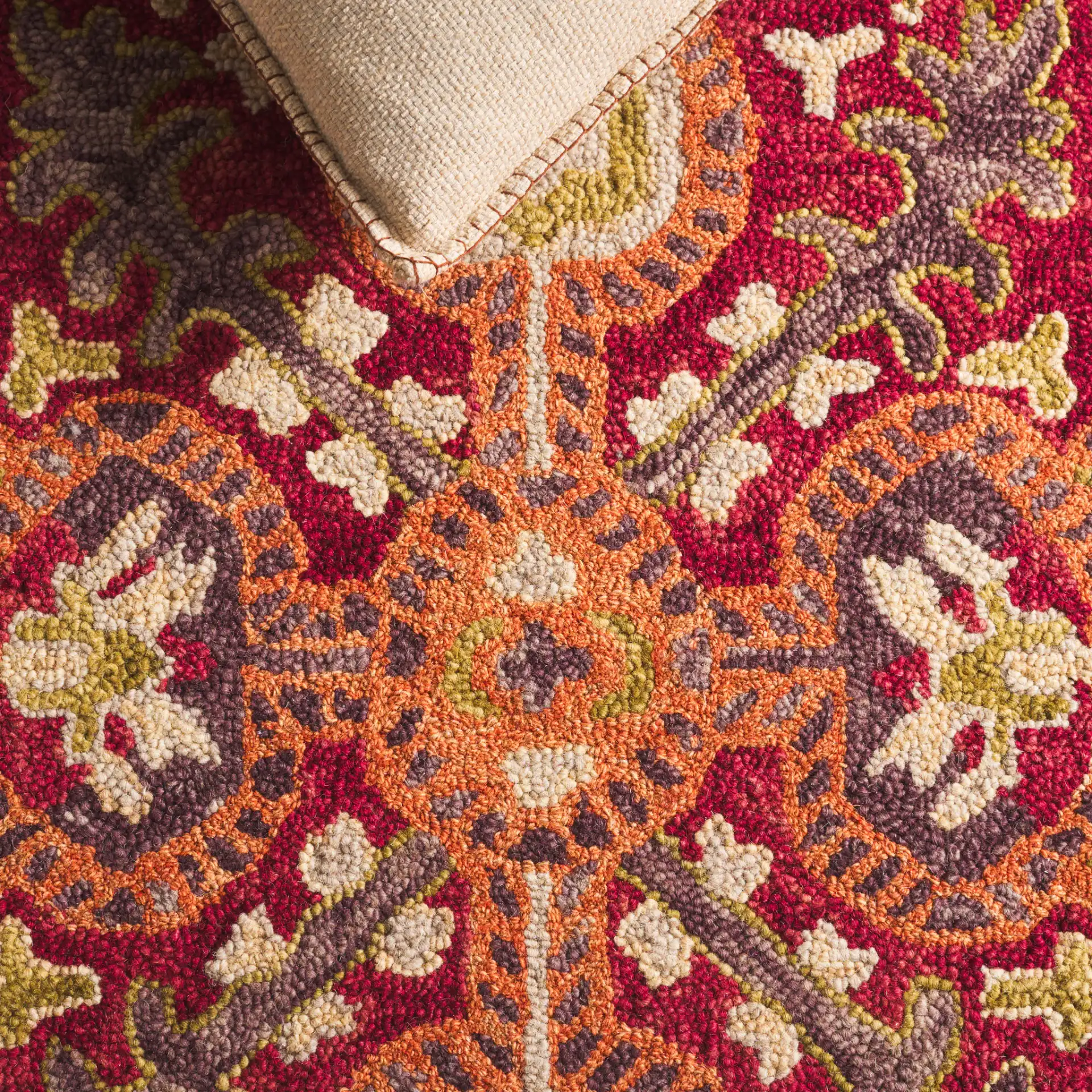 Aspen Tribal Diamond Medallion Hand-Tufted Wool Rug in Rust / Red in a styled room